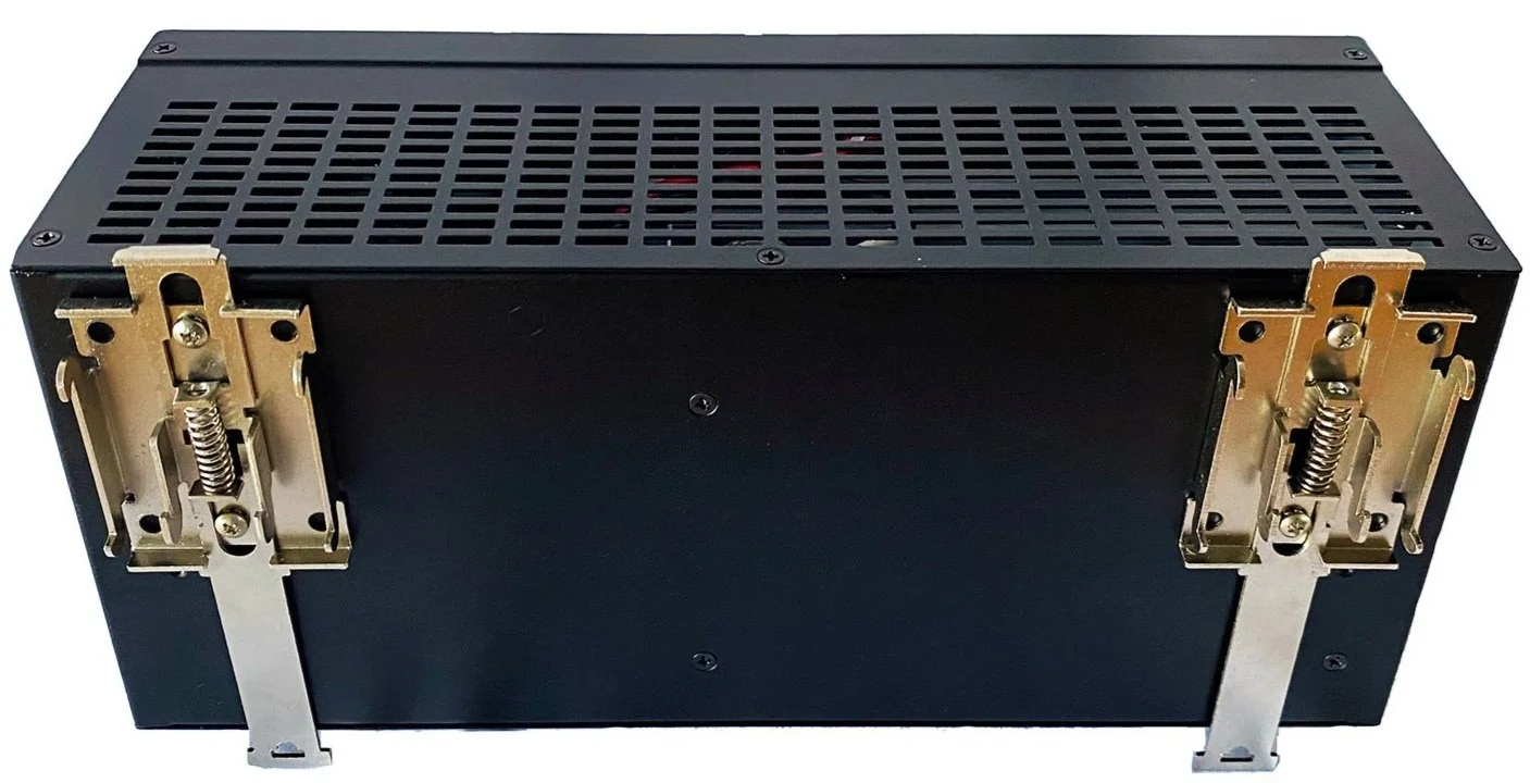 Black electronic device with metal mounting brackets on the sides, ventilation holes on the top, and a plain front panel.