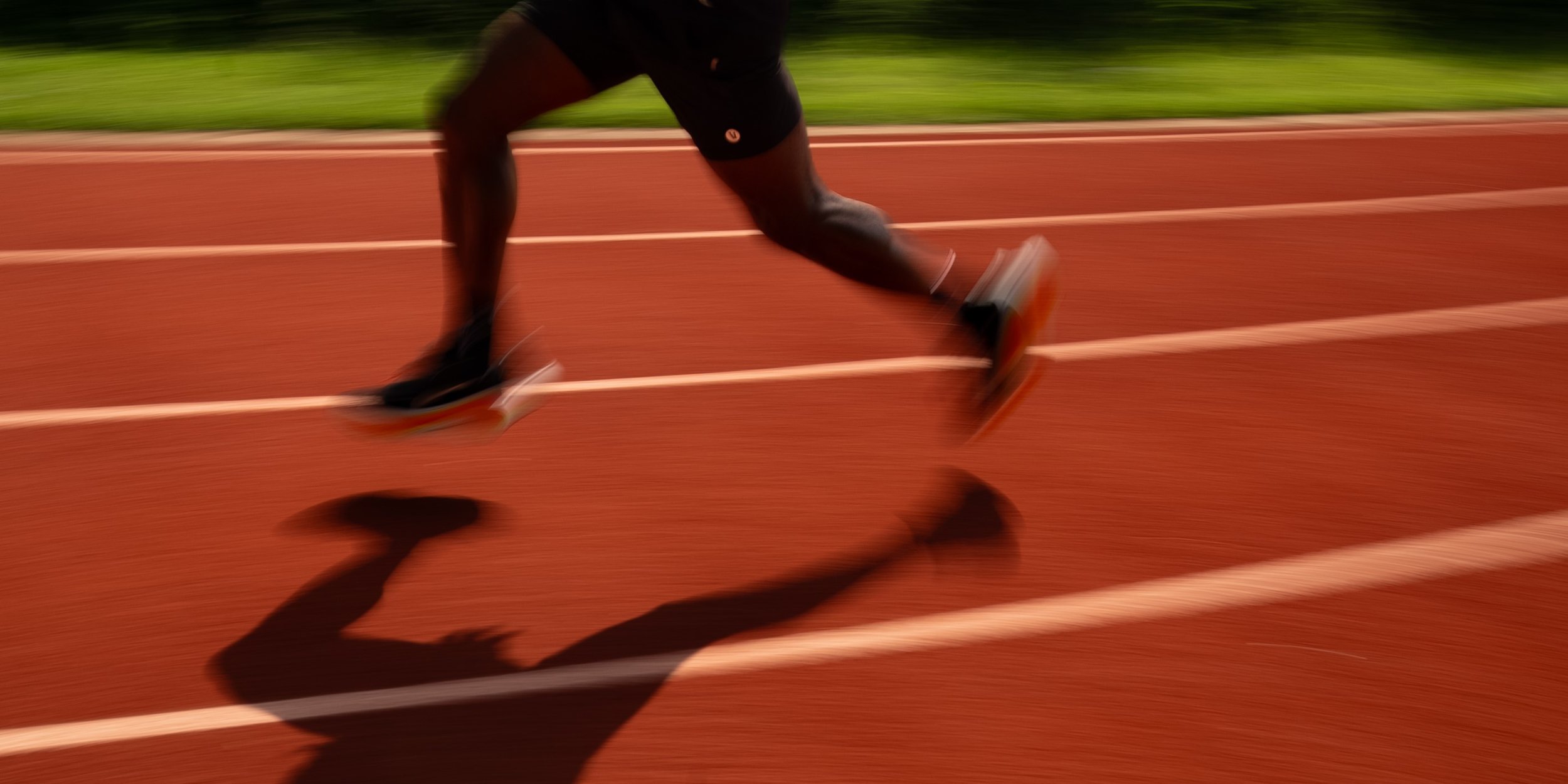 Runner rounding the track during a Sub-3 Initiative training session