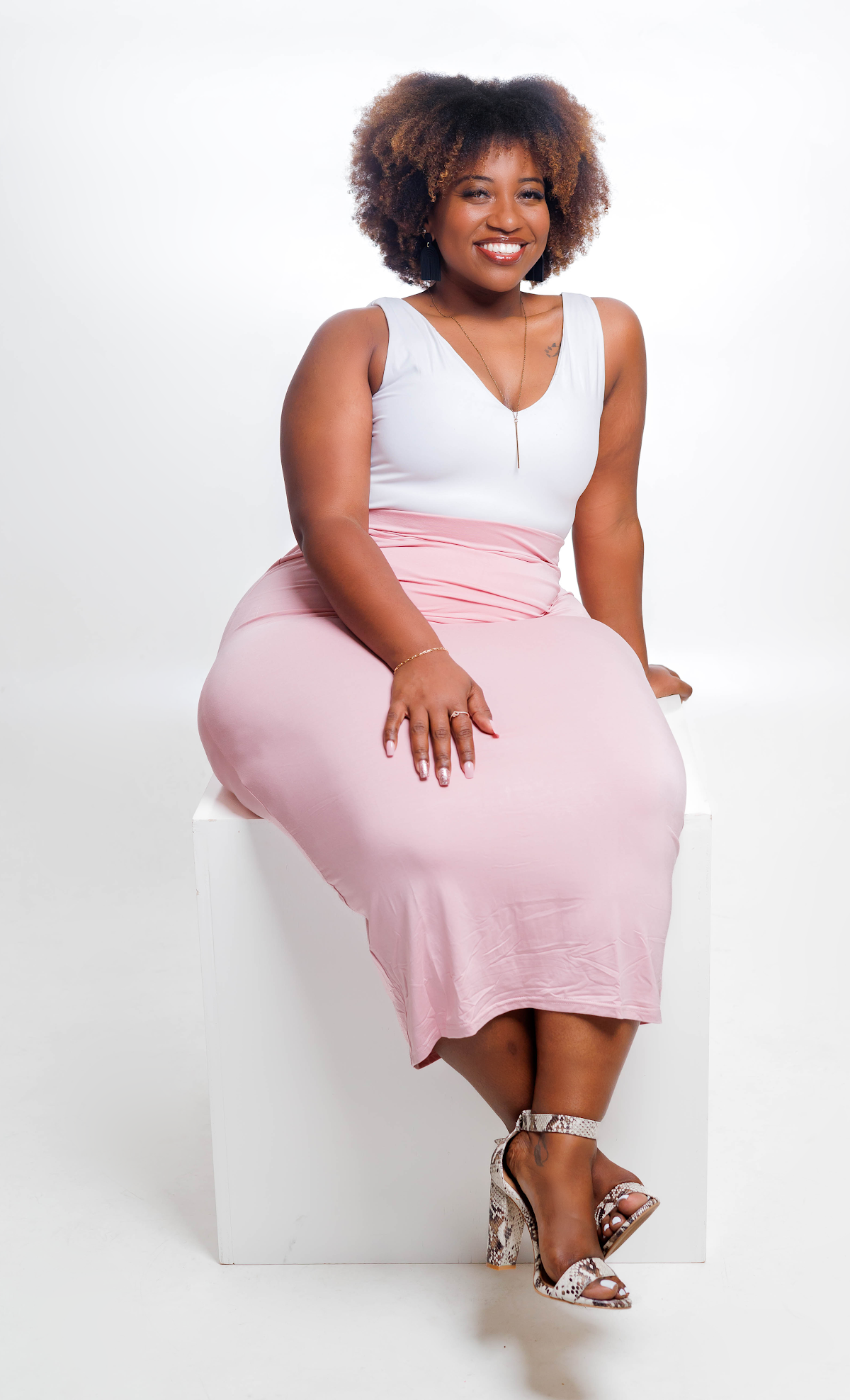 Jasmine Nance, a customer of A Level Up Rental Hall, seated and smiling for her testimonial portrait.
