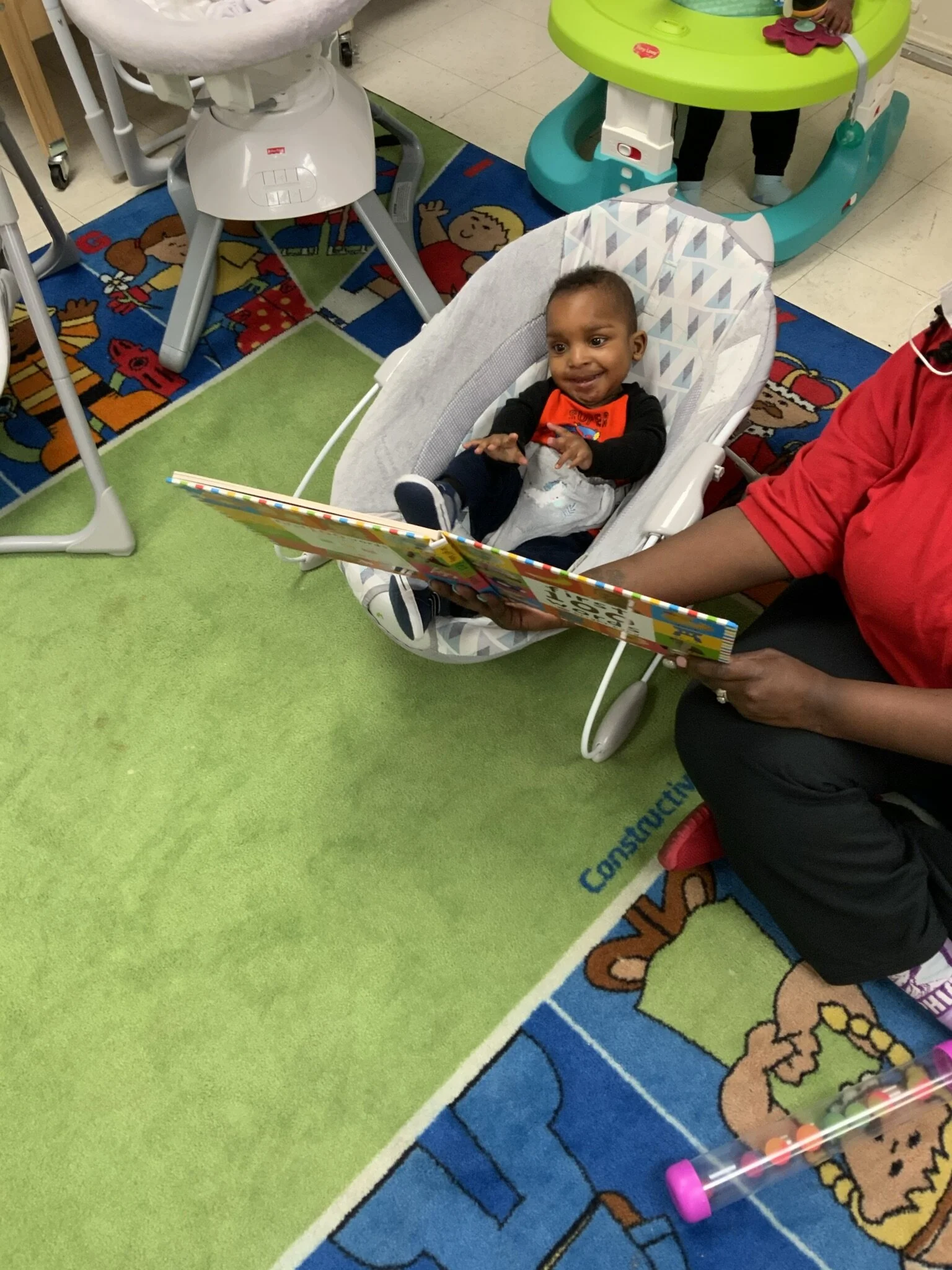 Teacher Reading to Infant