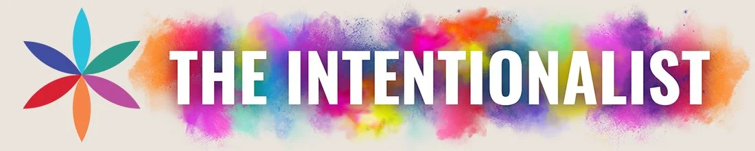 The Intentionalist Logo and Header. A flower made from the colourful logo. The Text has puffs of colourful powder behind it.