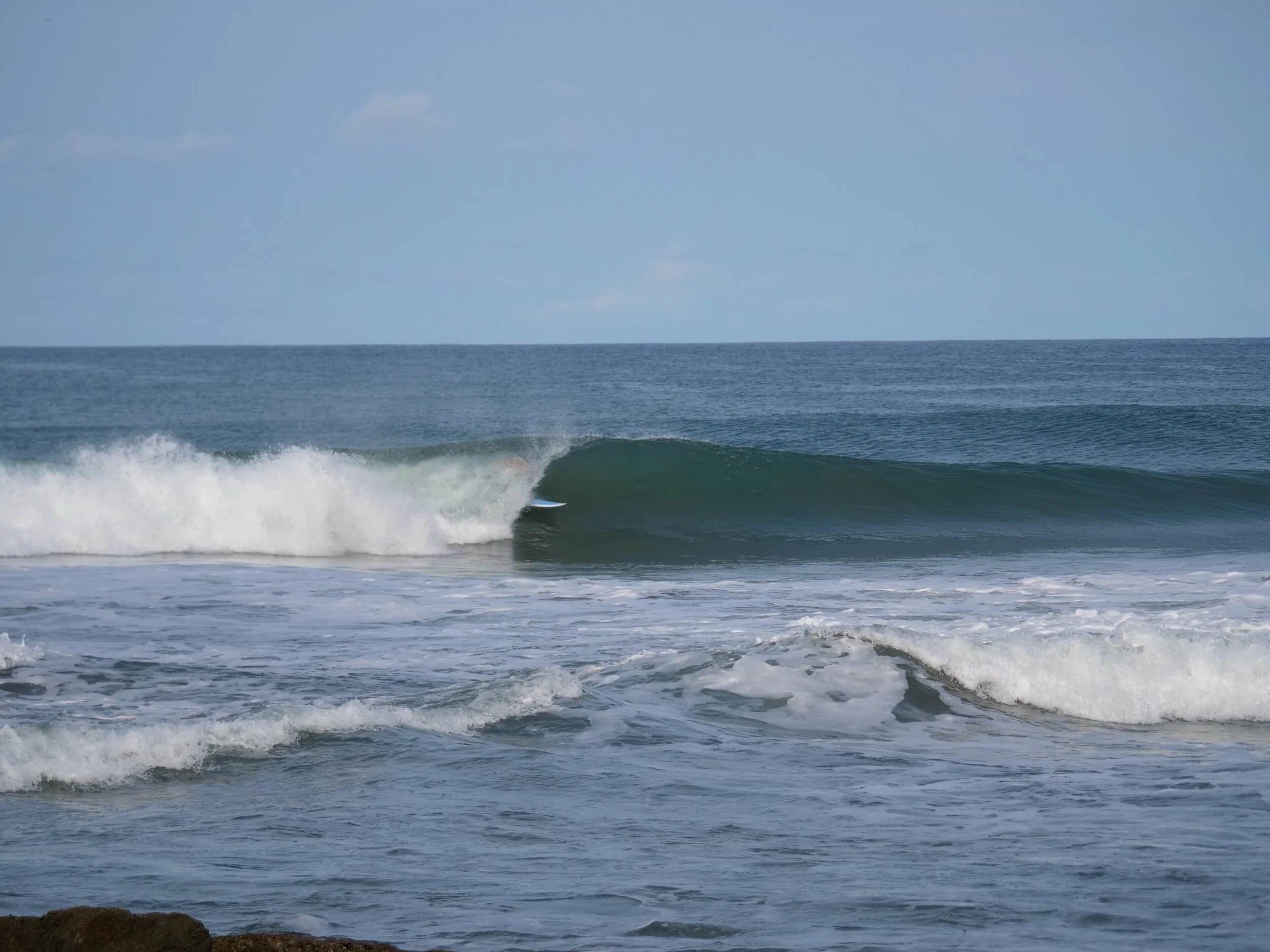 Surf catching wave at playa yankee 
