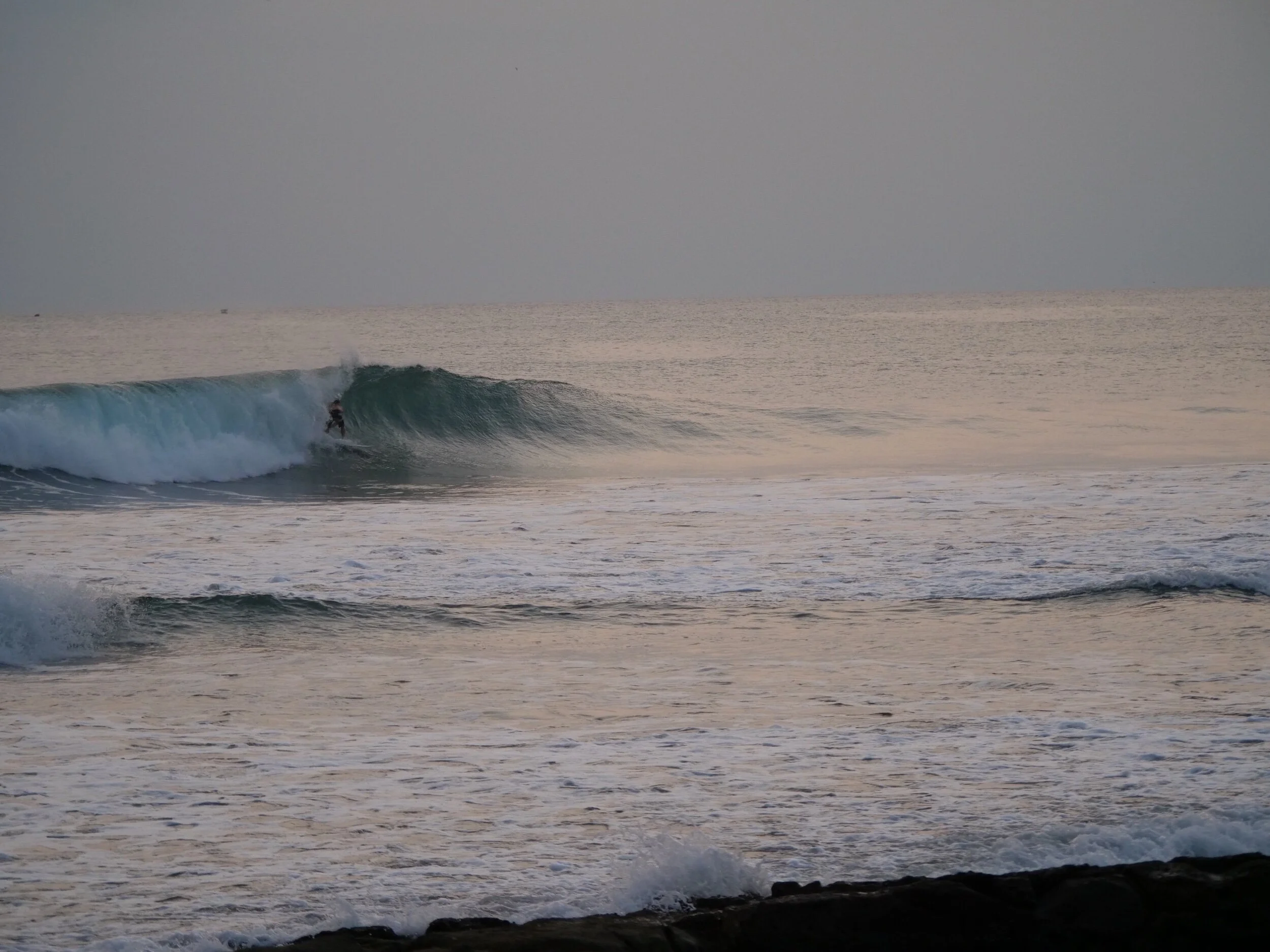 Surfer catching wave at Playa Yankee Nicaragua 