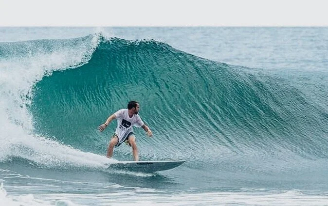 Surfer catching wave at Playa Yankee Nicaragua 