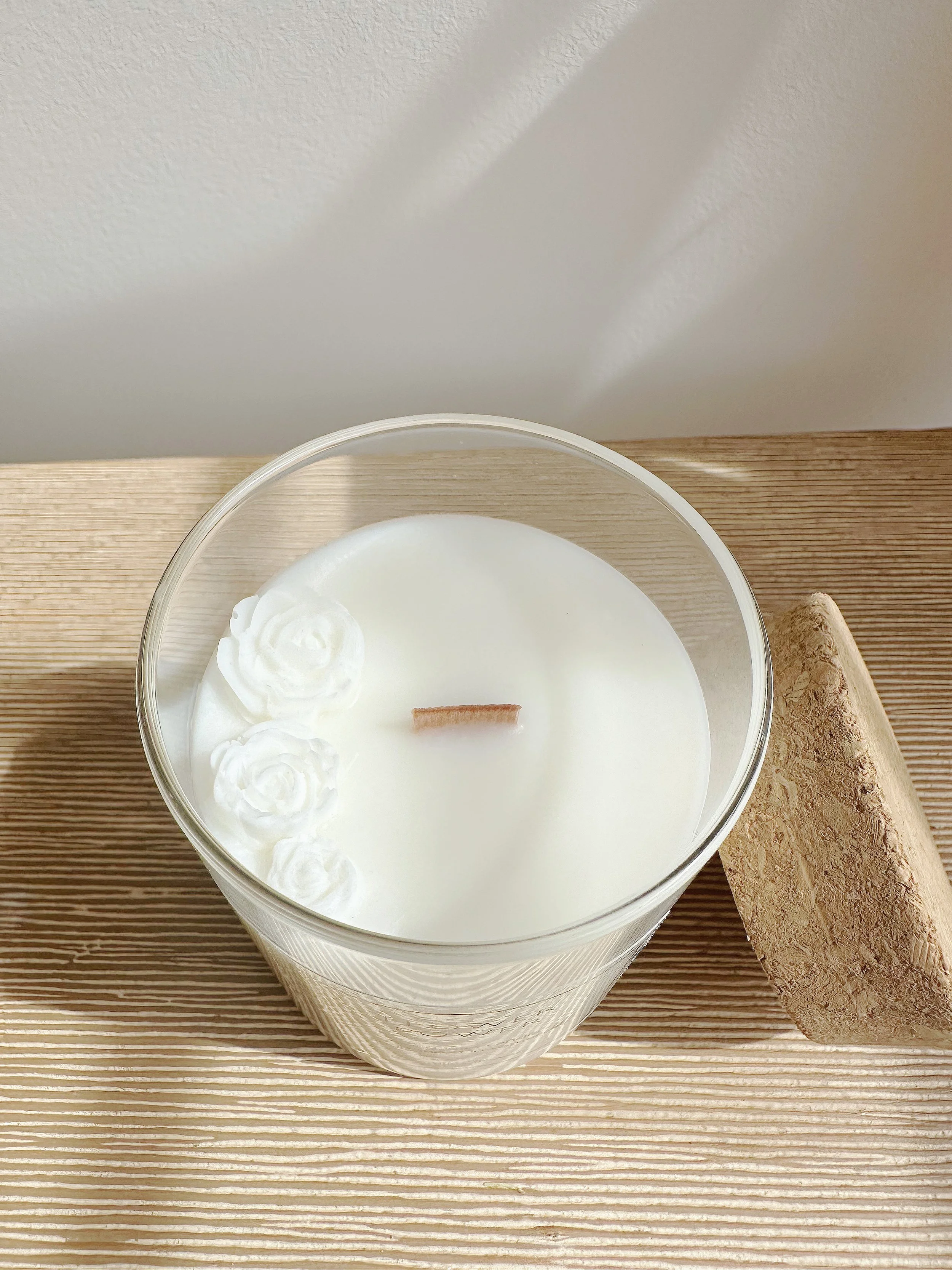 white candle with flowers on it