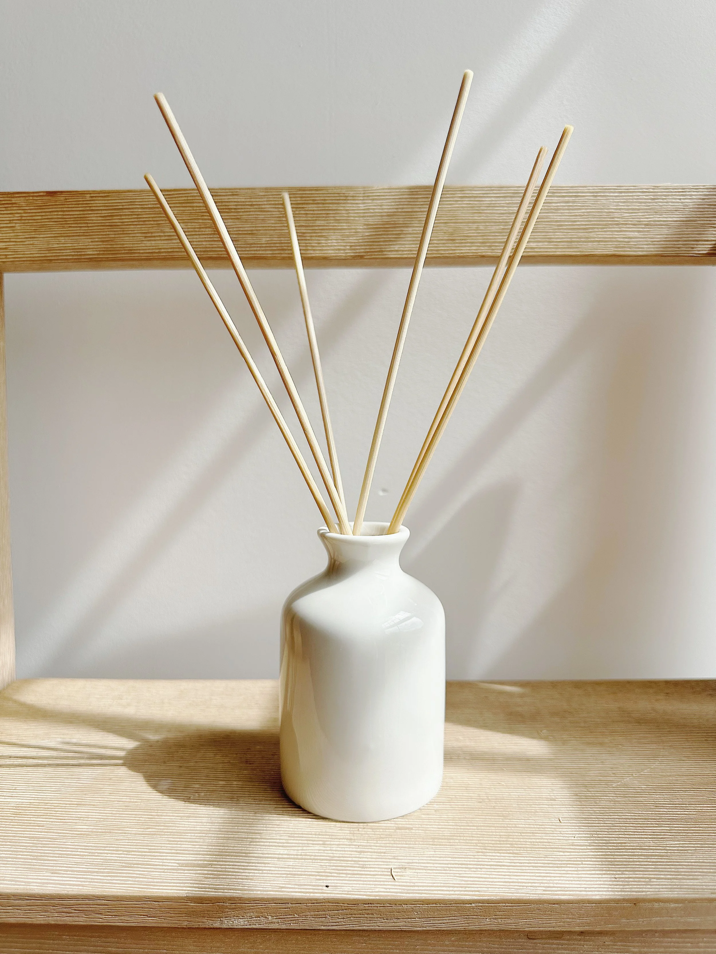 reed diffuser in white ceramic vase