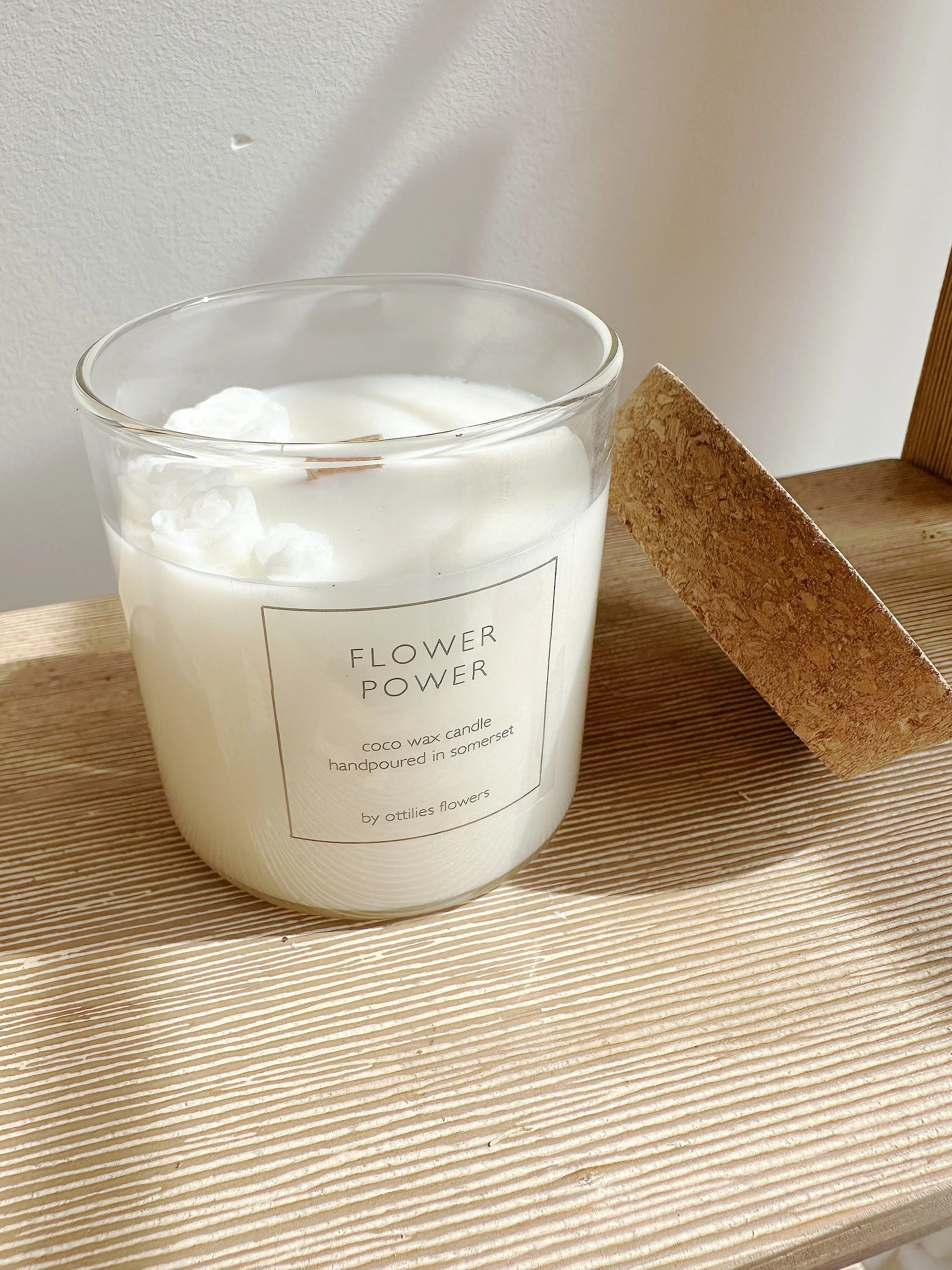 candle with flowers on it and cork lid