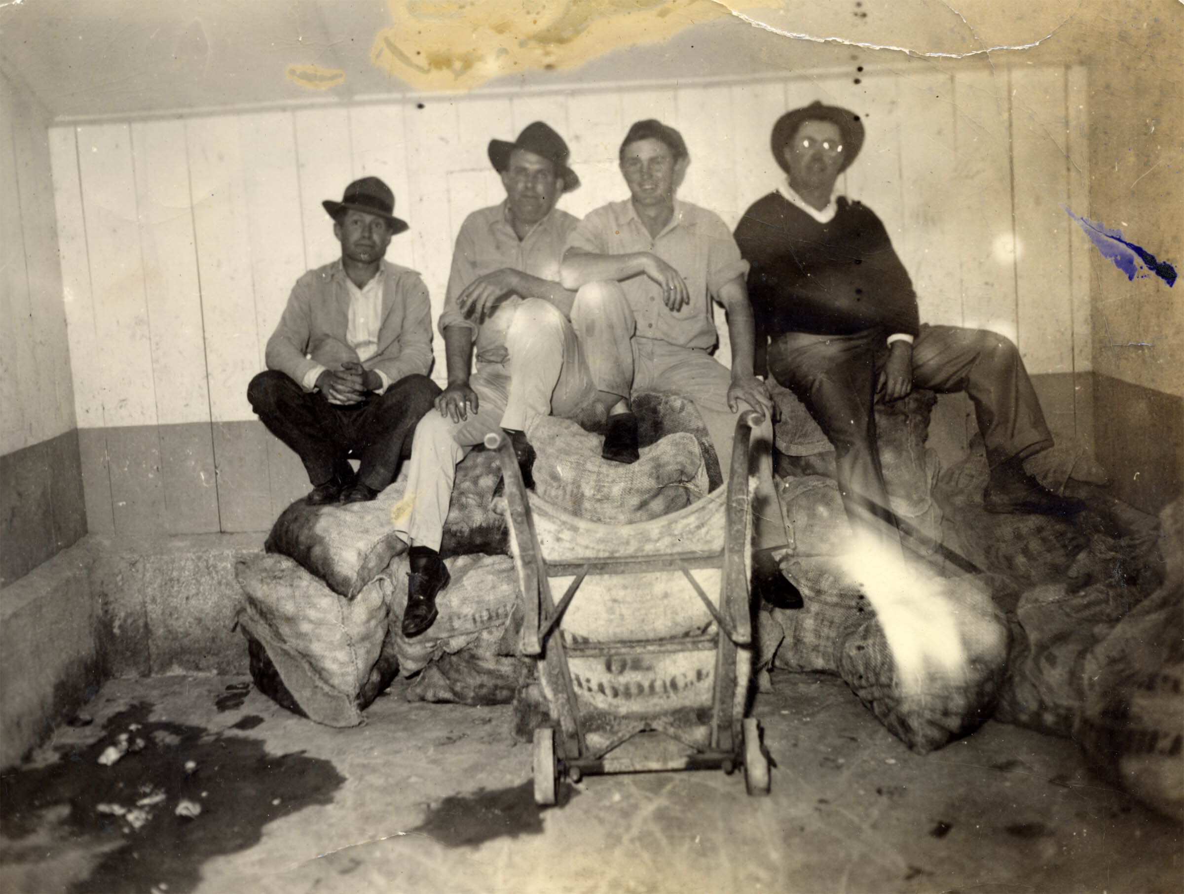 Men sitting on clams in Williston