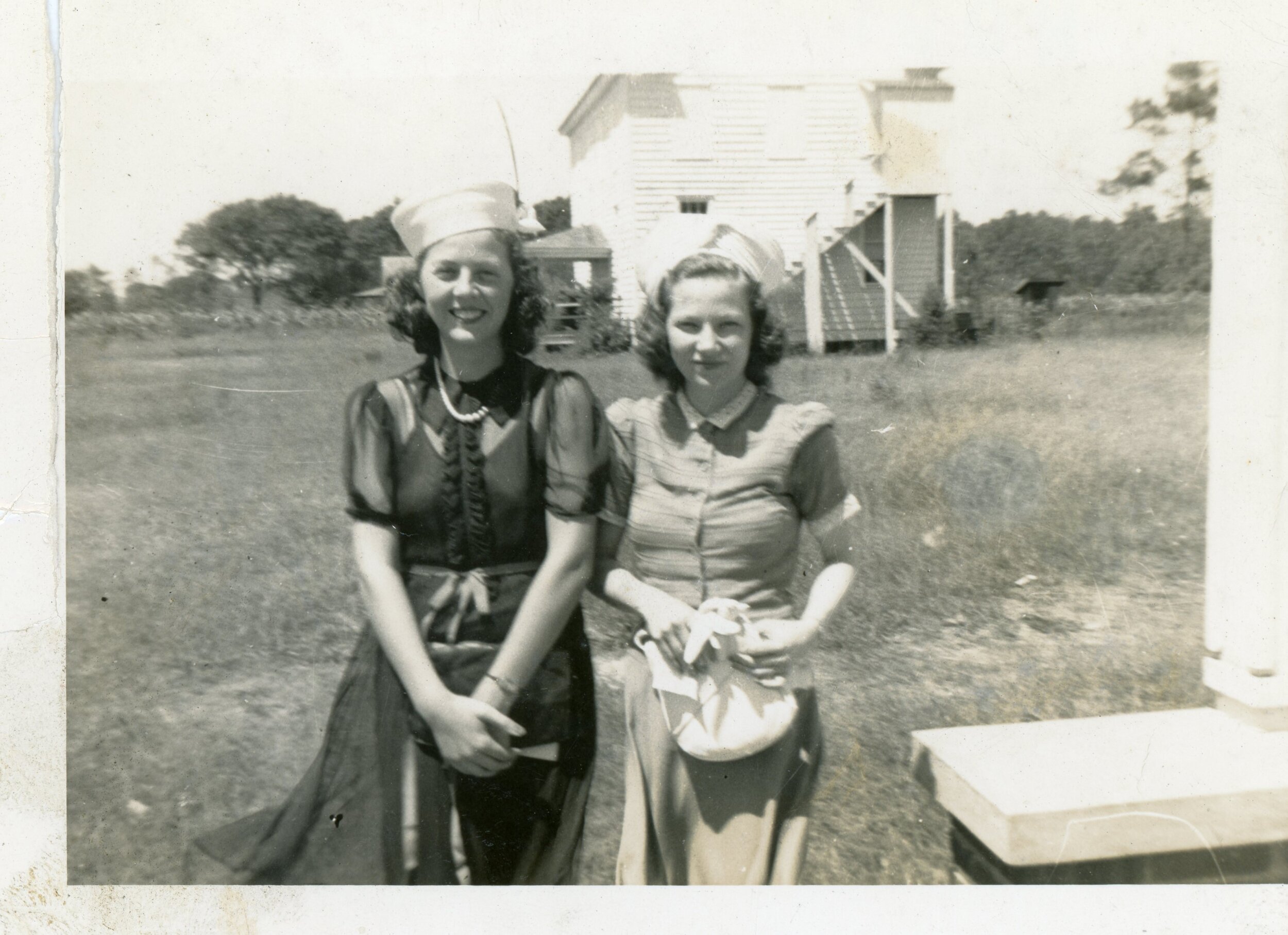L-R: Bertha Gray Chadwick and Annie Laurie Brandenburg McIntosh at Straits Church. Straits School building in the background