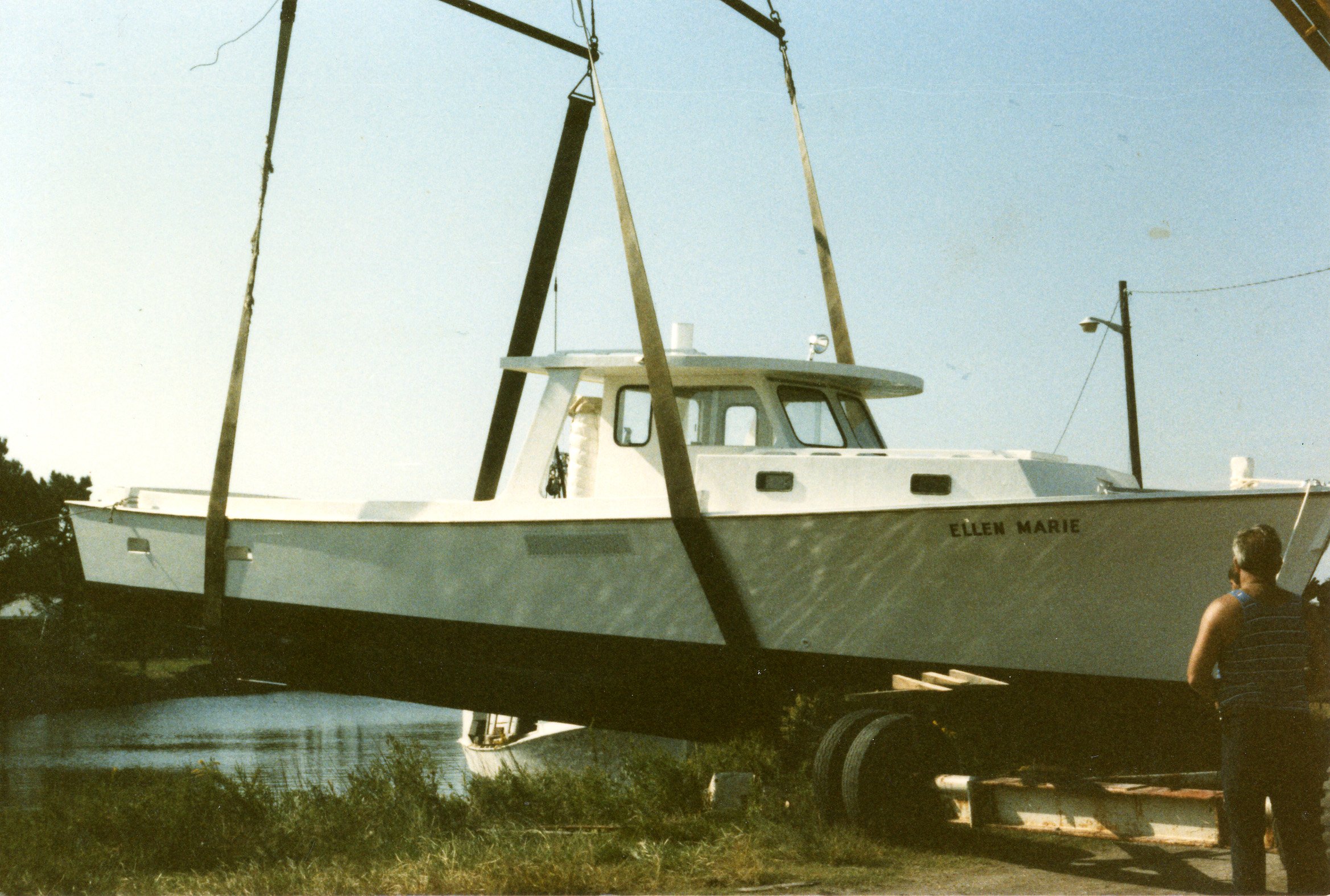 Dewey Piner’s crane putting the F/V Ellen Marie in the water, 1985