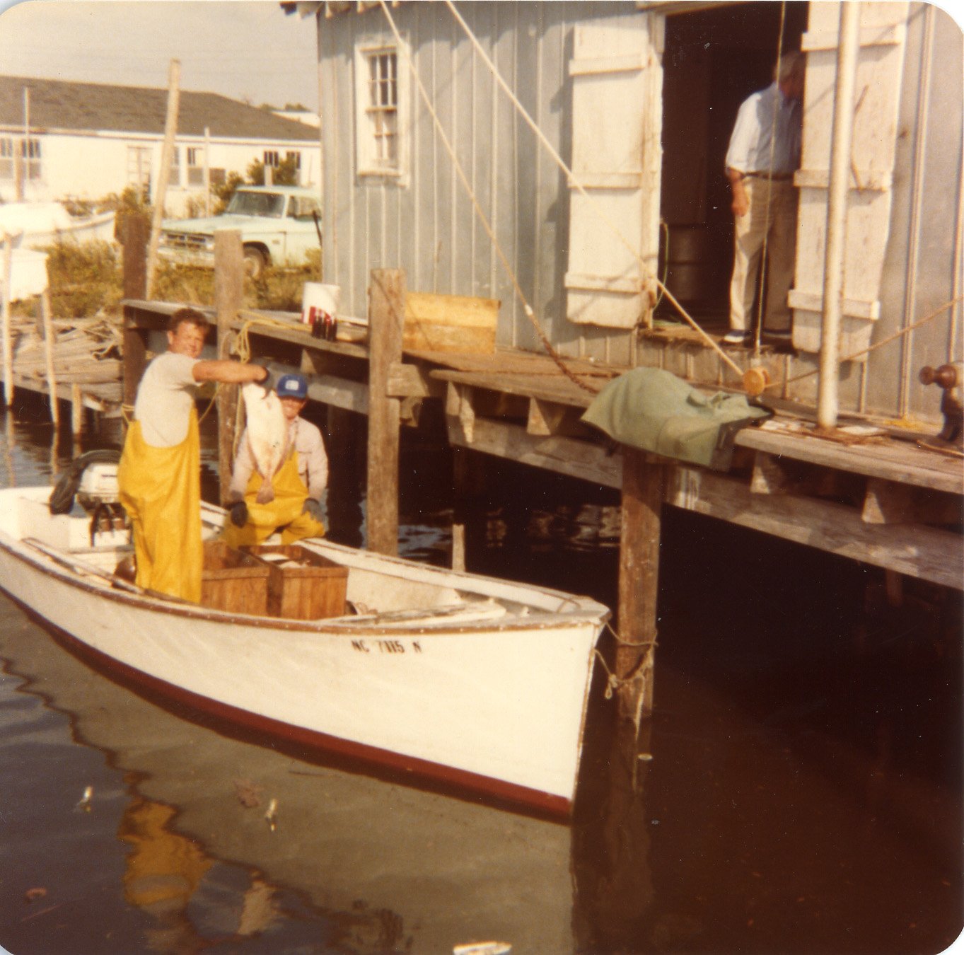 Benjamin and Red Brooks unloading clams at Clayton Fulcher’s Fish house, Harkers Island, 1970s.