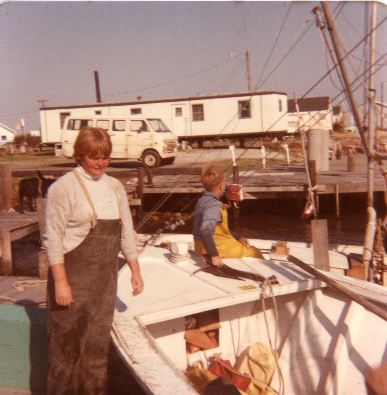 Mary Lou Rose with Rusty Brooks at Miss Harkers harbor unloading clams caught at the 12:00 shoals, 1978.