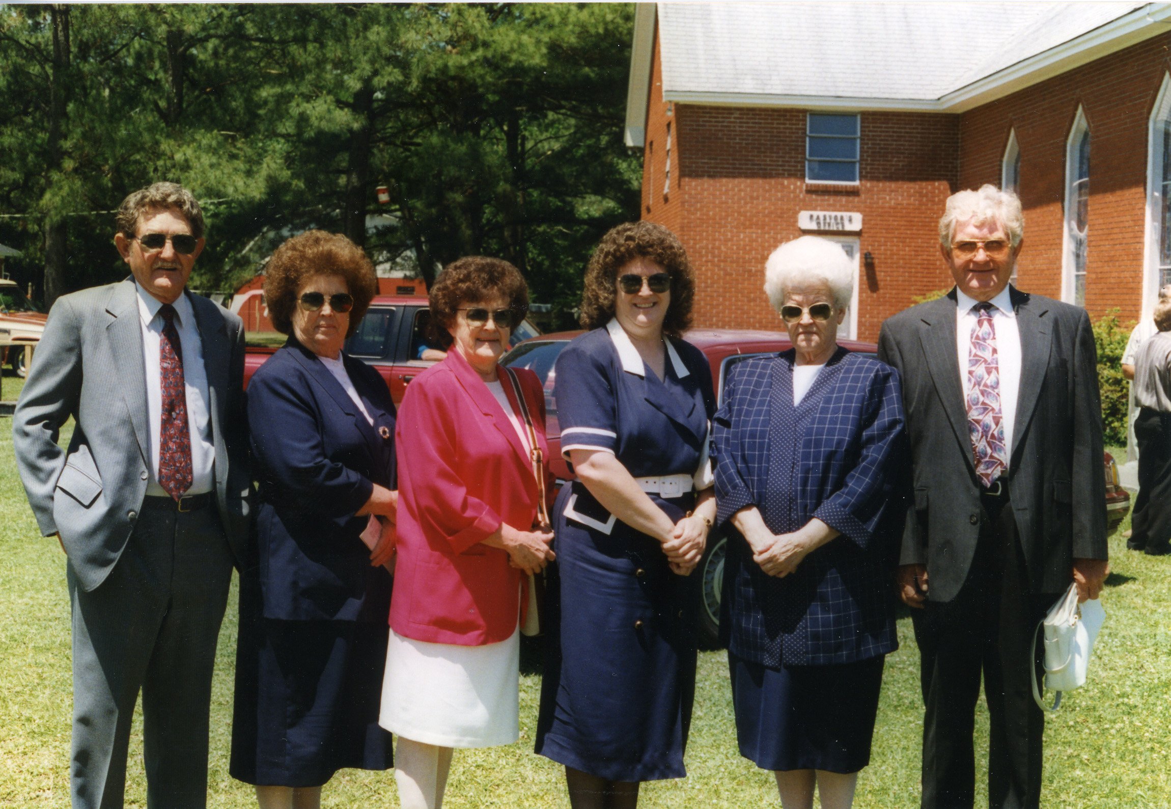 Four sisters and two brothers pose in front of the Harkers Island Pentacostal Holiness Church, 1995 or 1996. 