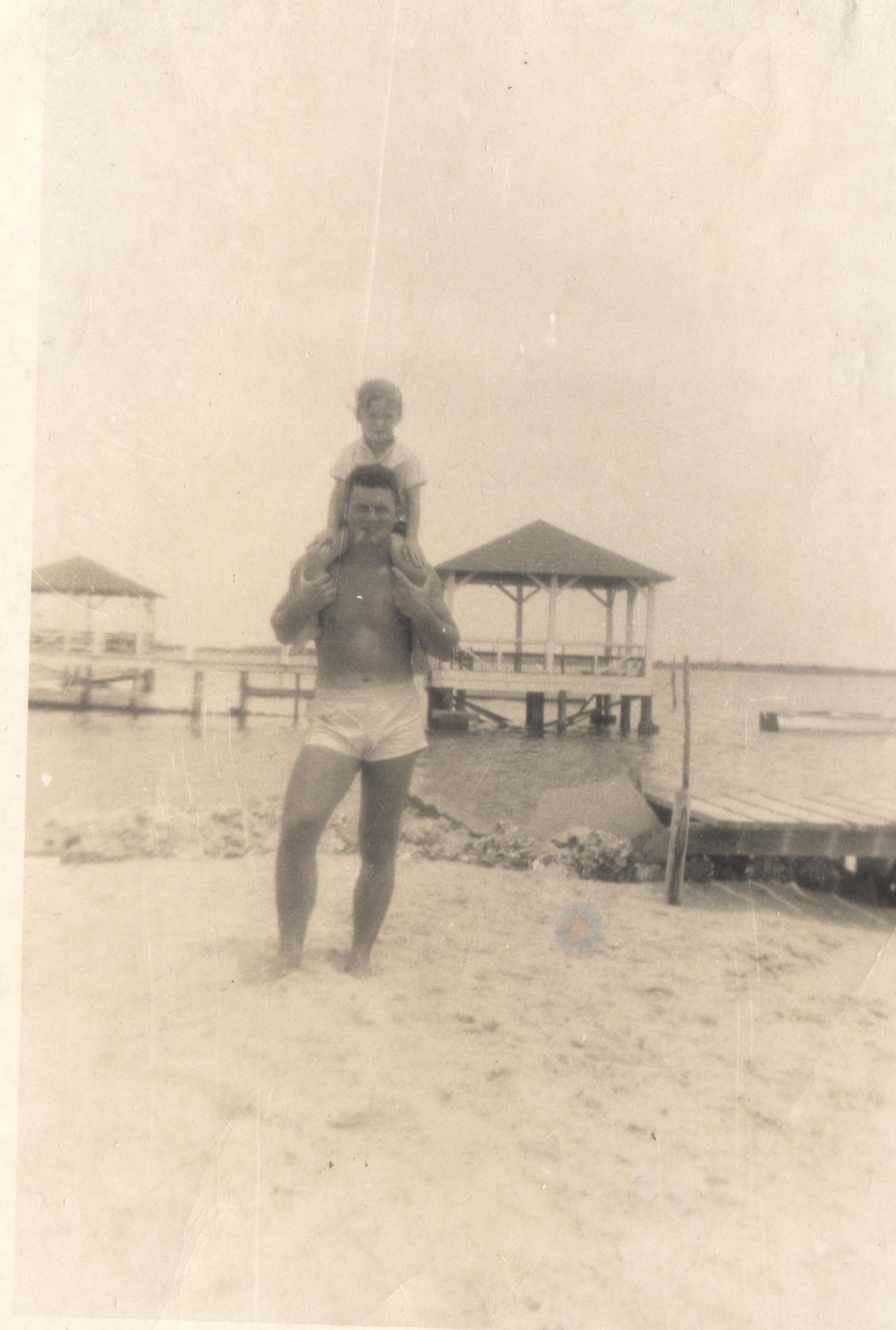 Bill May and unk child.  Boathouse in background was for the Edwards house, which now belongs to Mason Williams