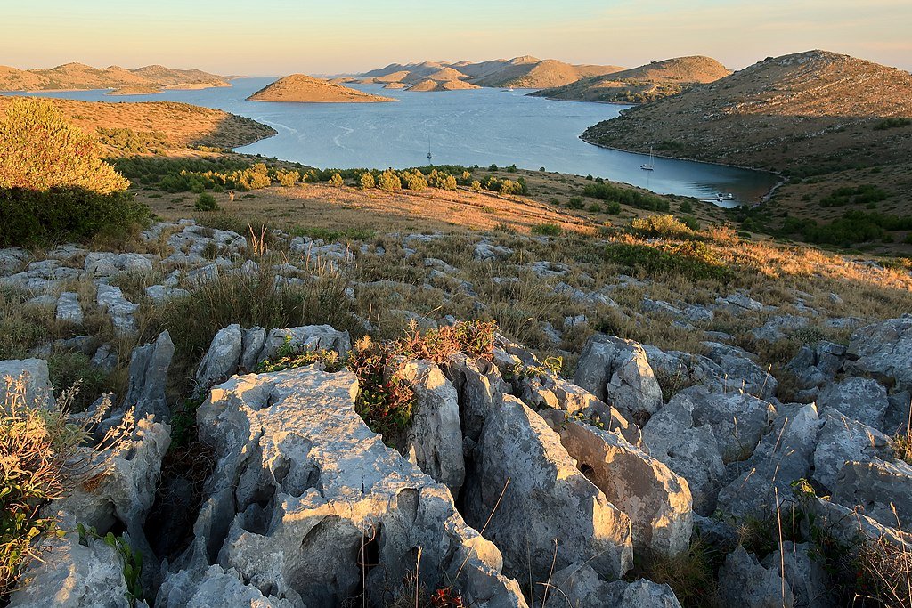 A view of the many Kornati islands seen from a rocky hill just before dusk.