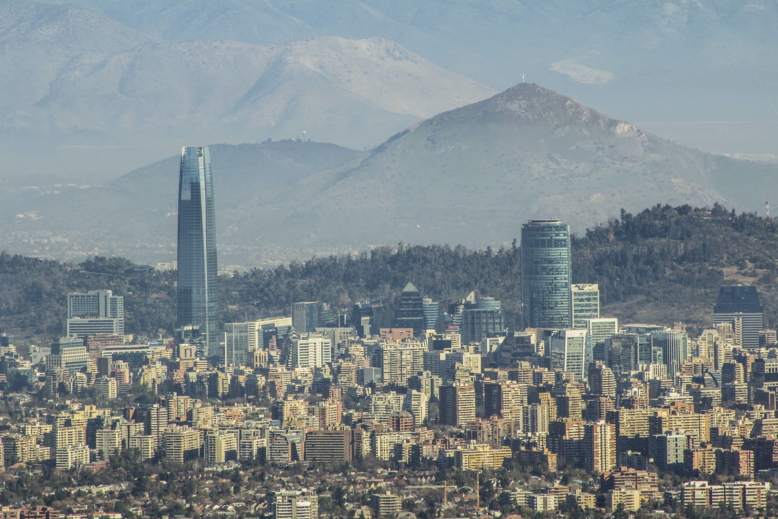 A view of Santiago's eastern districts, including Providencia and the Sky Costanera skyscraper, with the Andes mountains in the background.