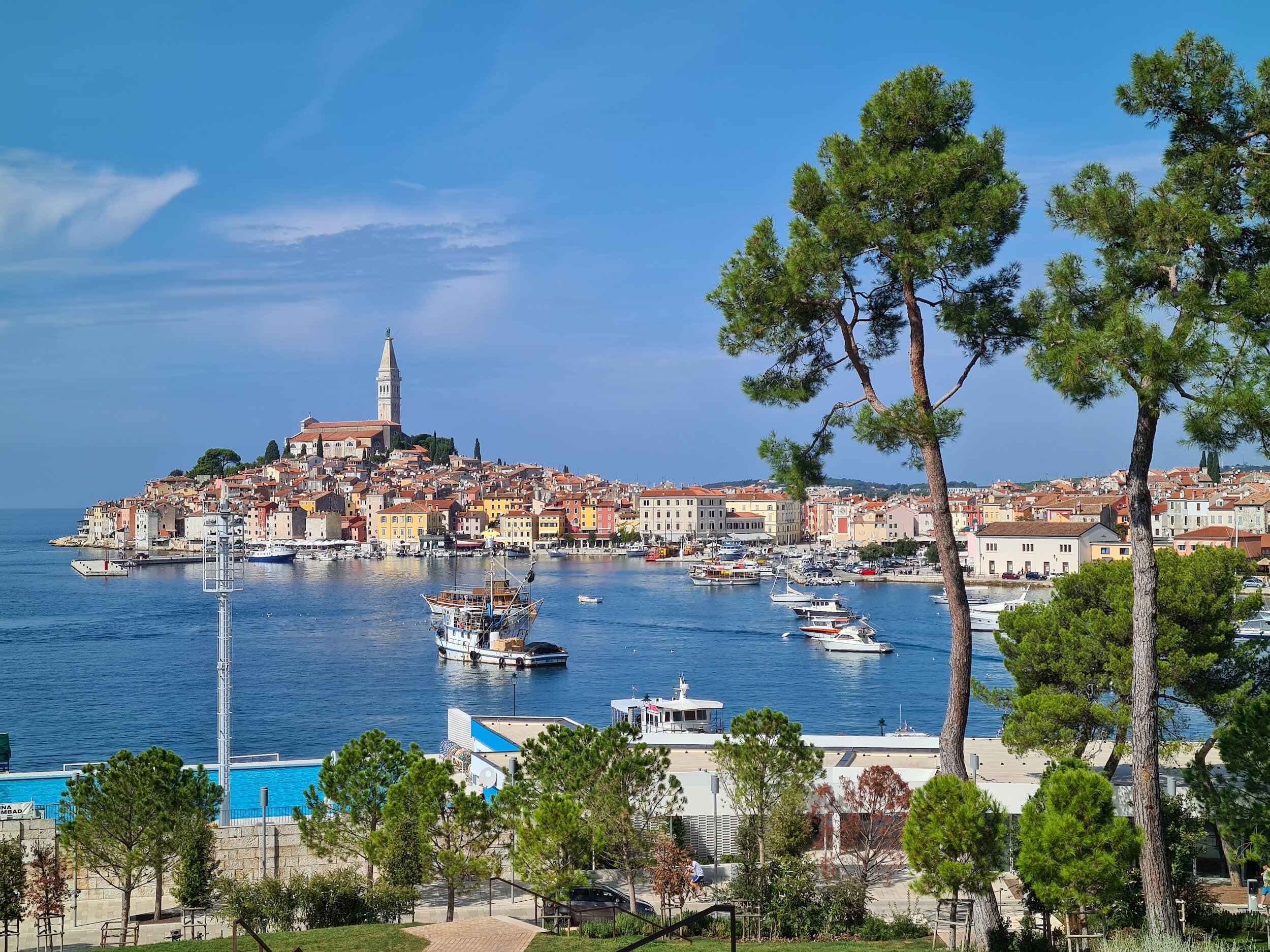 The beautiful Istrian town of Rovinj on a promontory in the water with its church steeple rising high above the town as seen from across the water