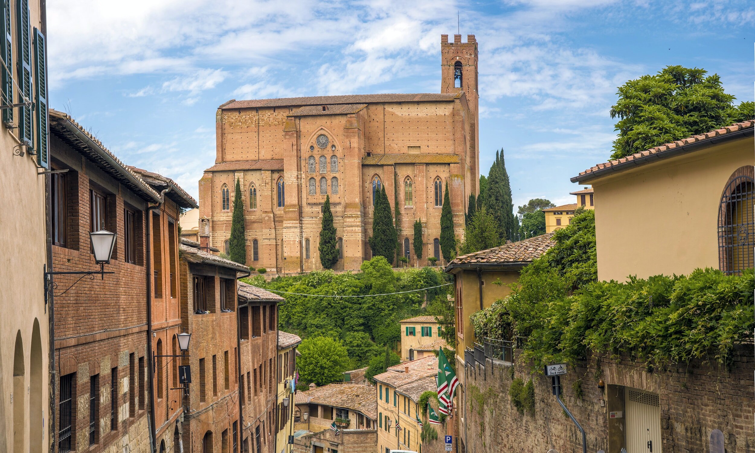The enormous Basilica Cateriniana di San Domenico in Siena, Itlay, seen from a nearby street towering over the city