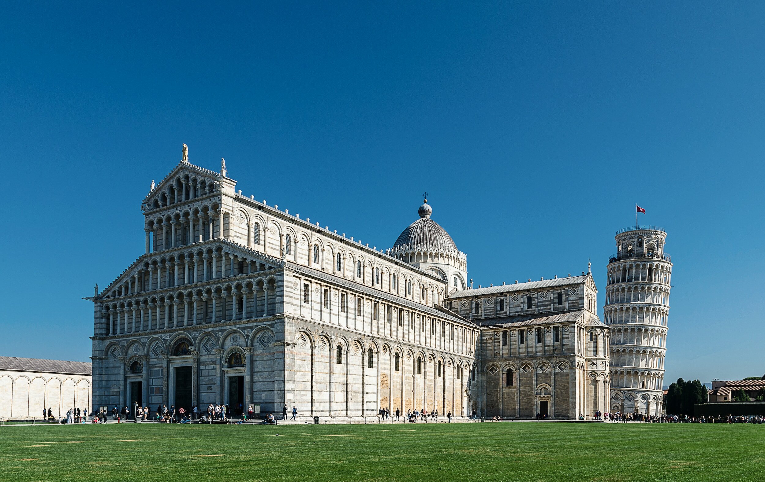 The Cathedral of Pisa, with the Leaning Tower of Pisa behind it, seen from across the Piazza del Duomo Square