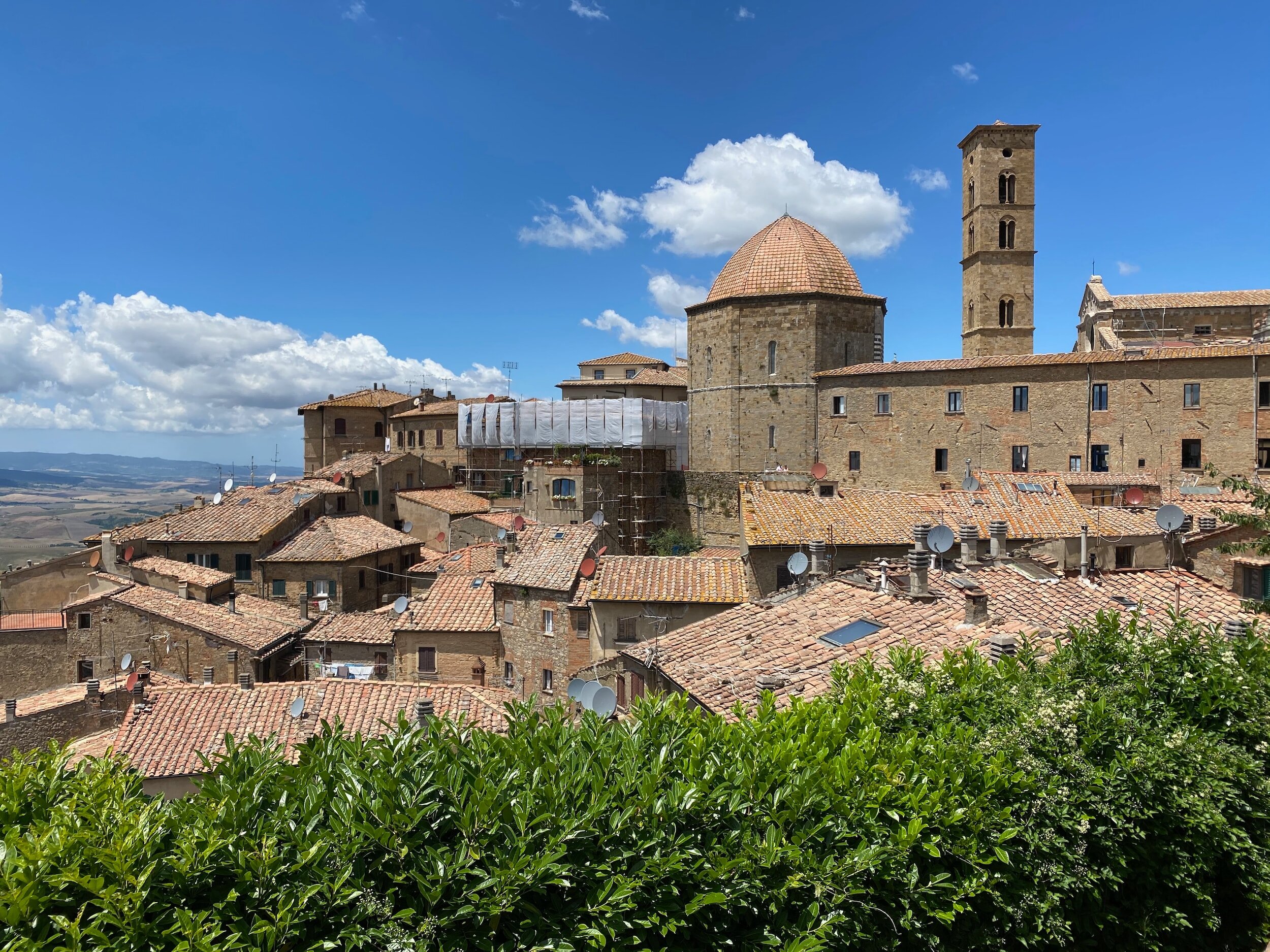 Looking out over stone buildings and their red roofs in the town of Volterra in Tuscany
