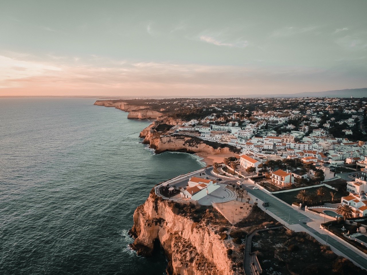 An aerial view of the lovely town of Portimão and it's beaches and rocky coast at dusk in the Algarve.