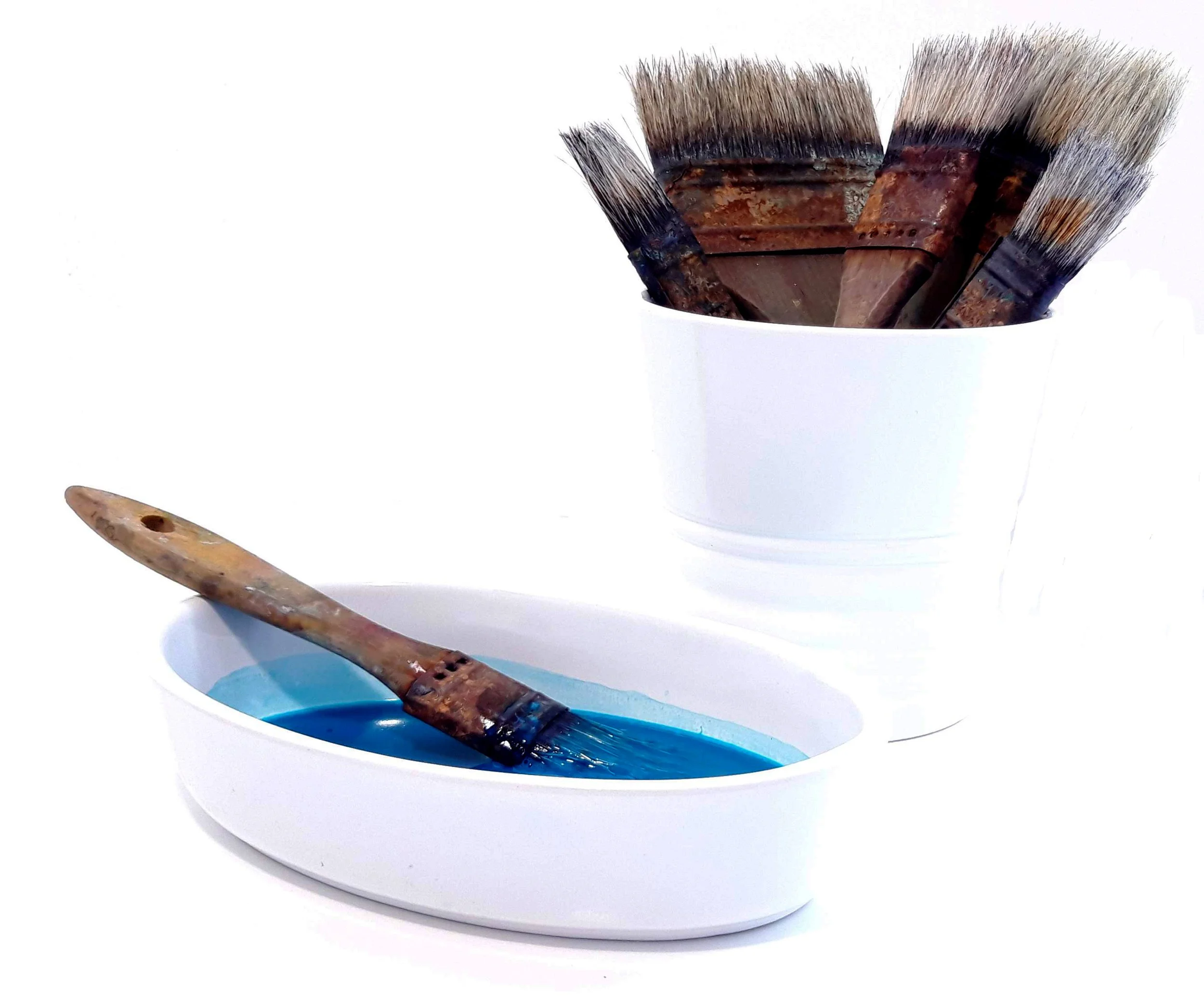blue fabric paint in a bowl with brushes in a pot