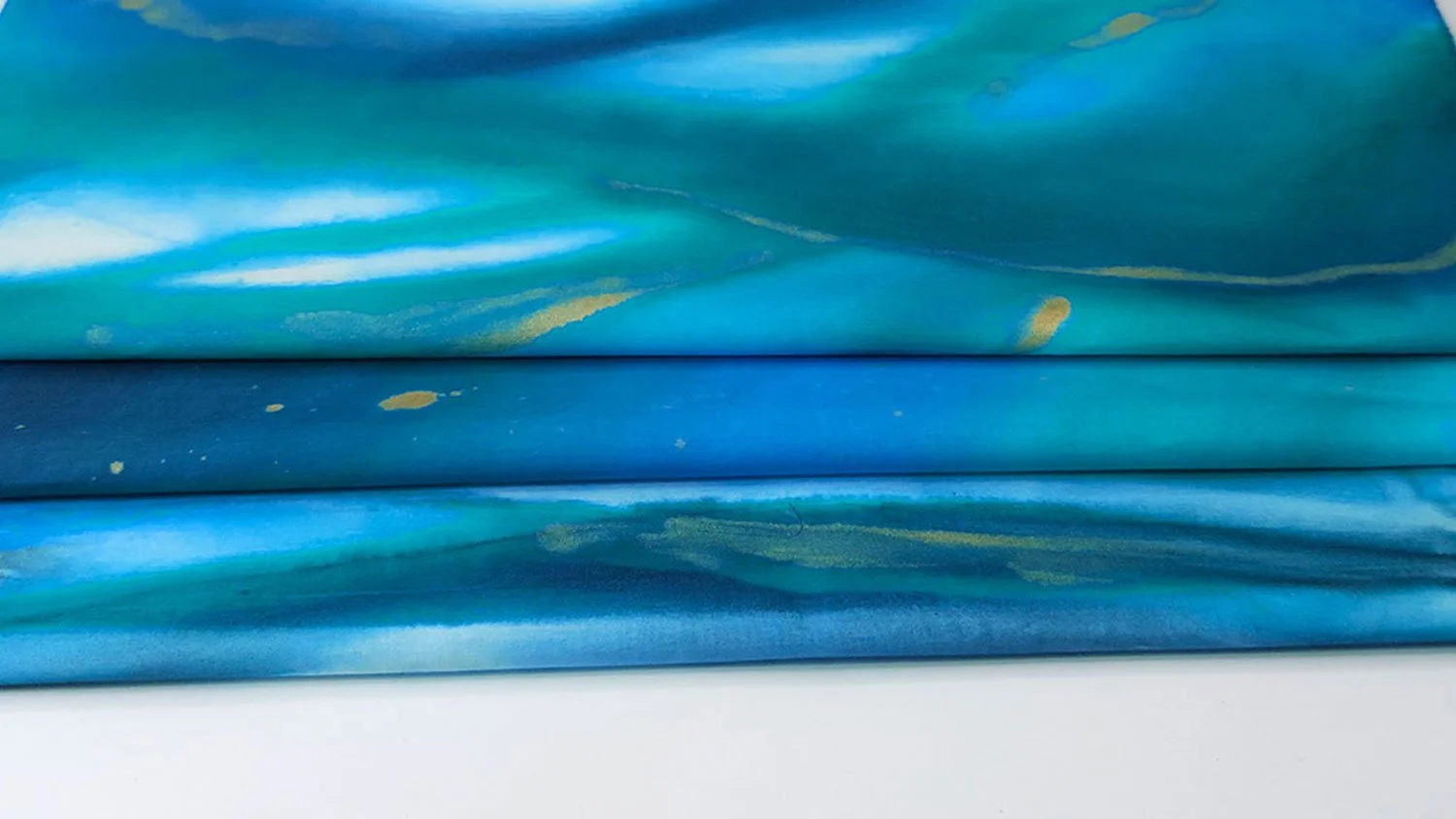 sea themed, blue green painted quilt fabric with specks of gold