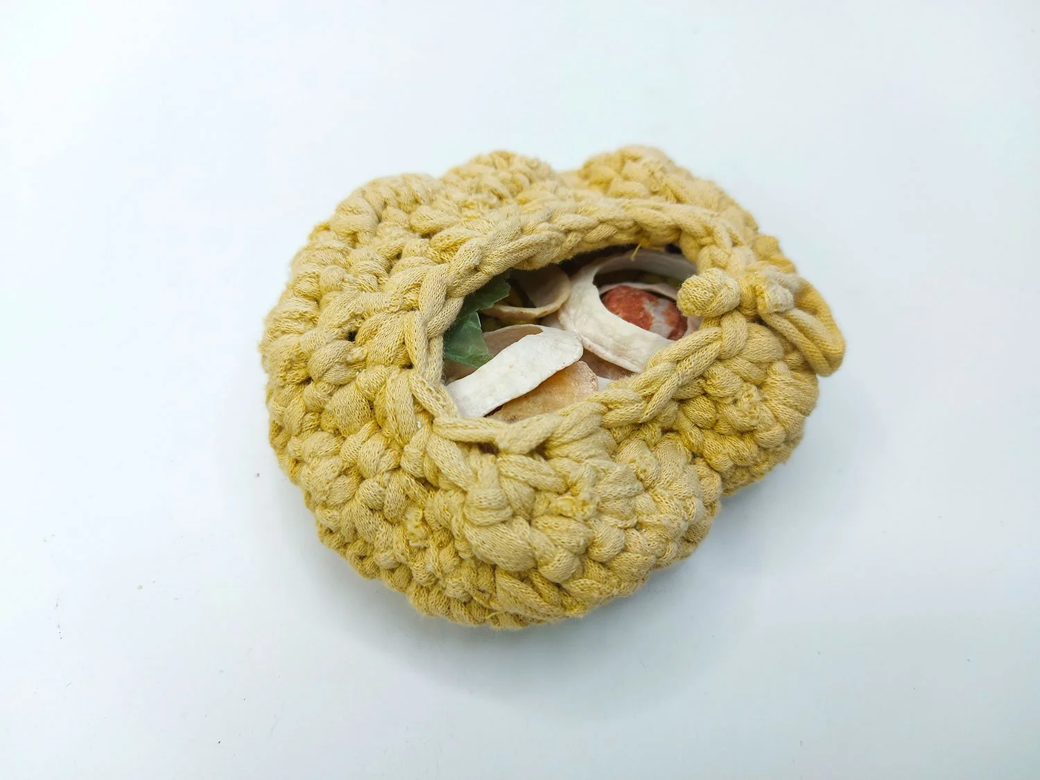 Crochet vessel inspired by sea urchins made old clothing.