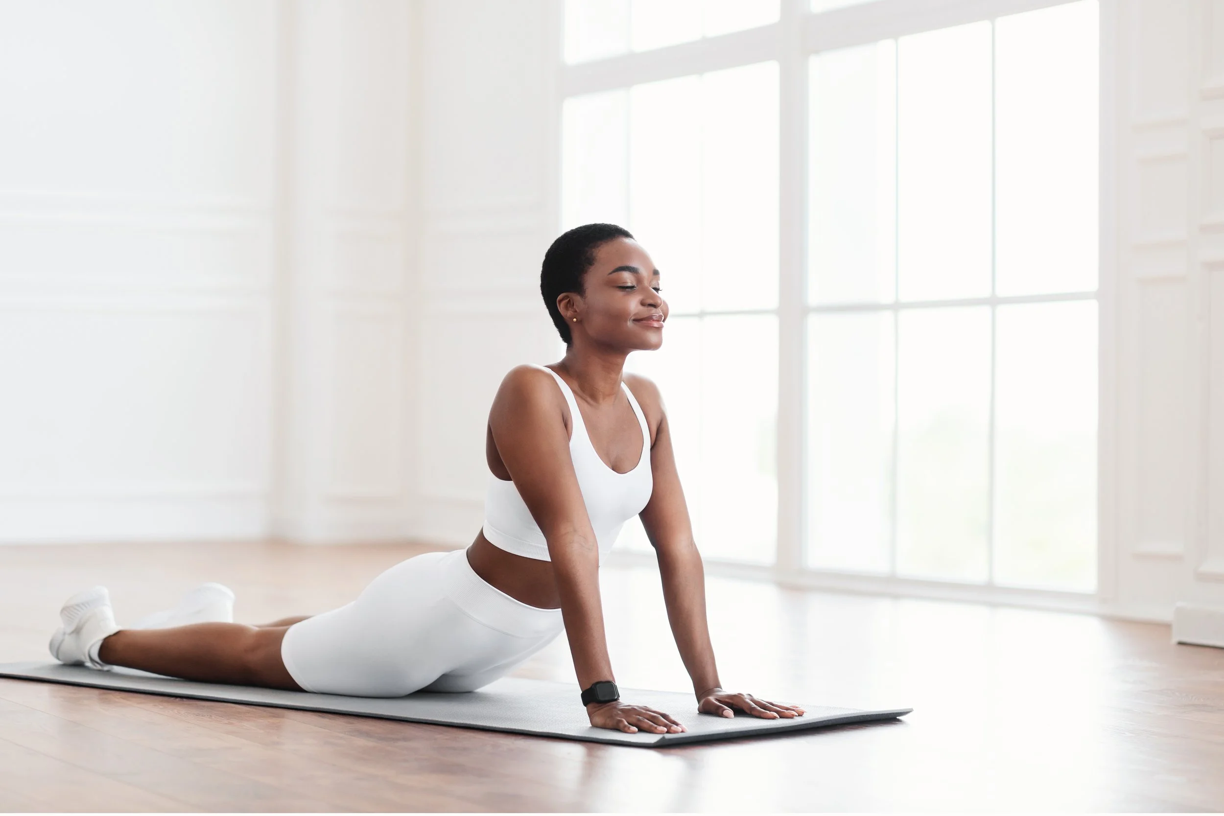 calm-black-woman-stretching-back-on-mat-in-cobra-p-2022-12-16-07-01-08-utc.jpg