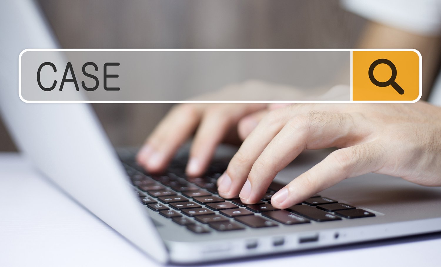 photo of hands typing on a laptop with a graphical element overlaying the photo. The graphic element is a search bar with the term case entered