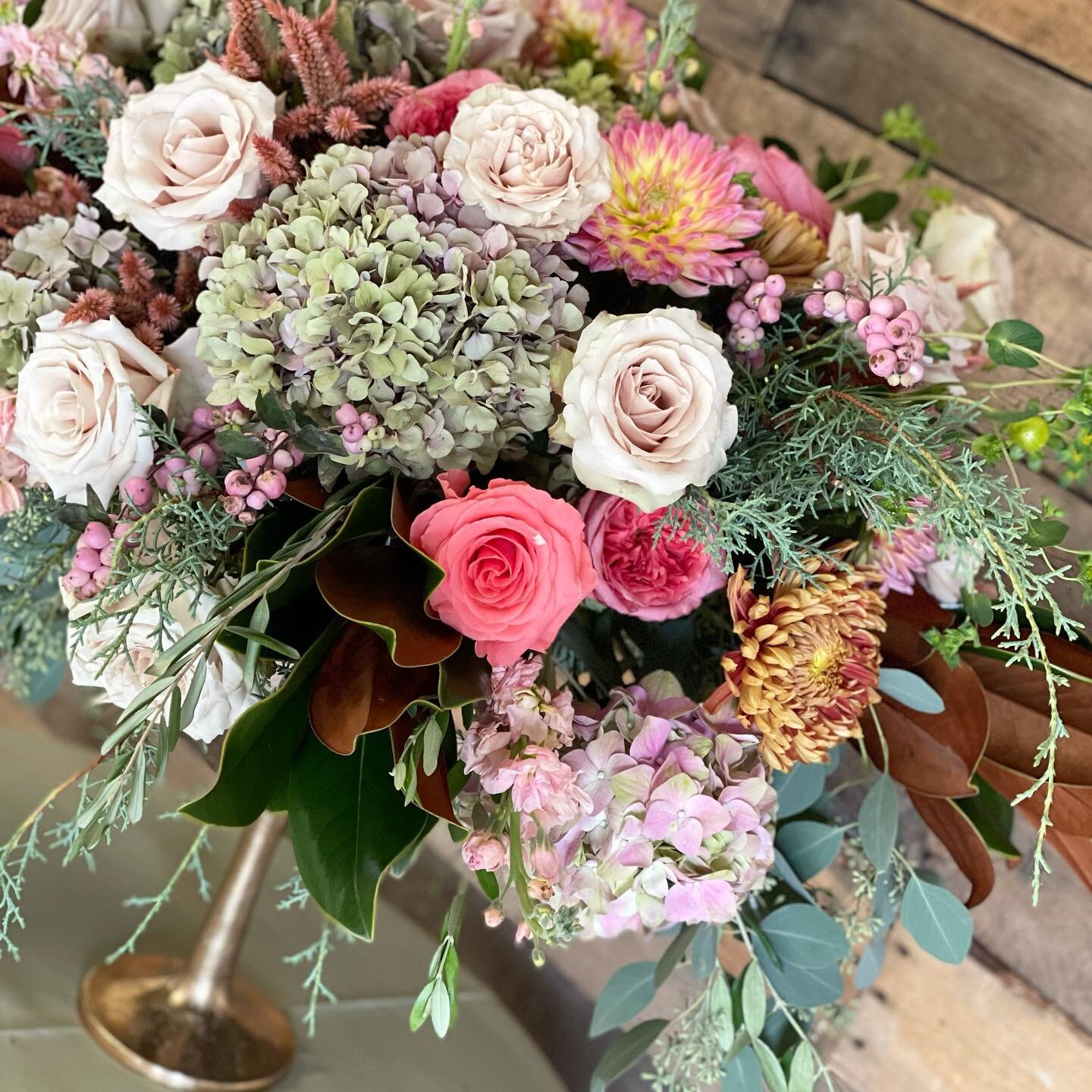Design inspiration from @andreakgristfloralart at our recent open house at @florasourcekansascity. Pretties include sapphire cedar, magnolia, antique hydrangea, peach stock, lisianthus, pink snowberry, celosia, roses in several shades, dahlias, and o