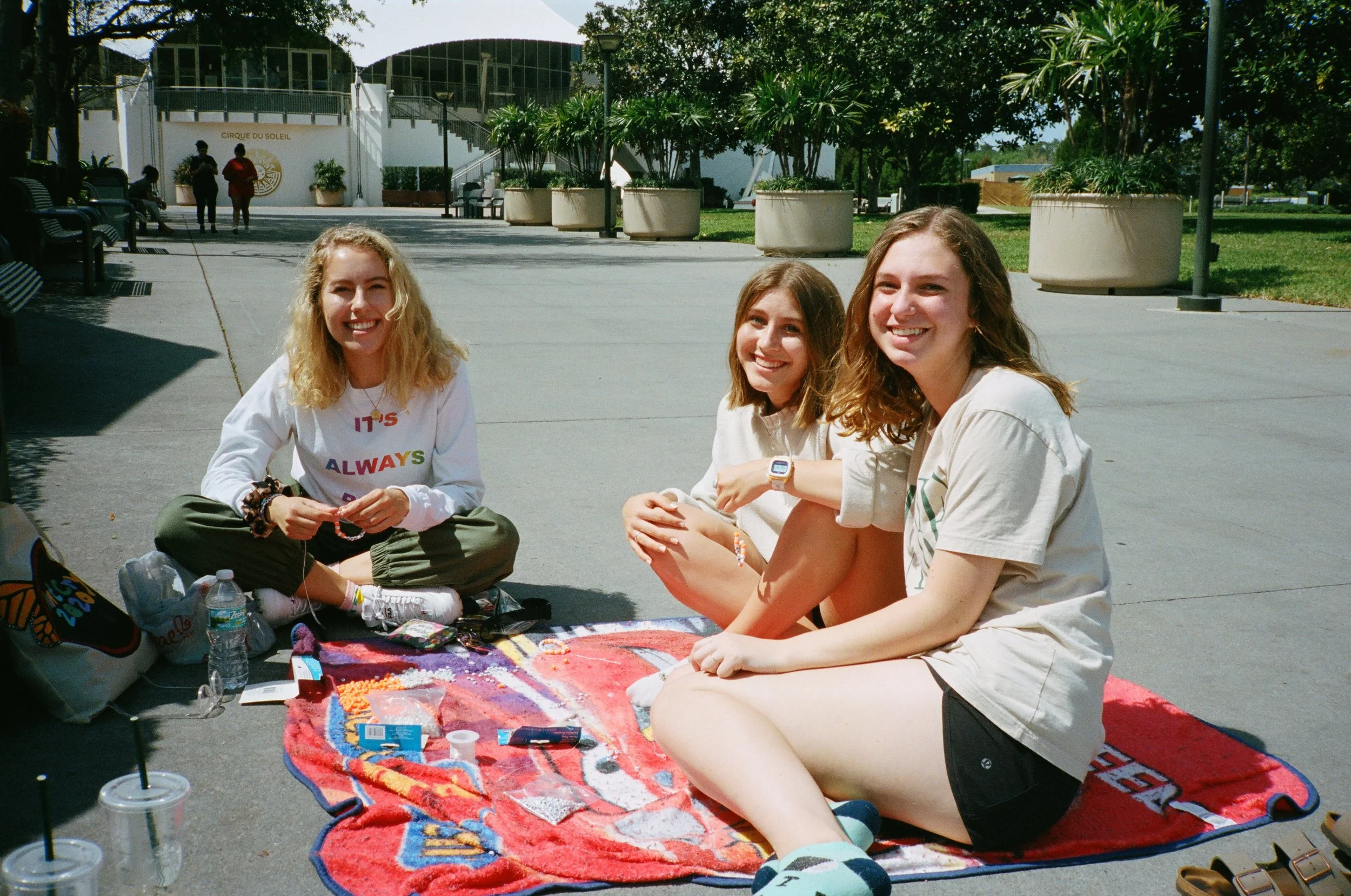 Making bracelets for people in line.