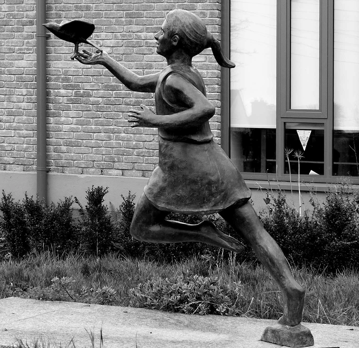 In front of the school as are the remaining images.