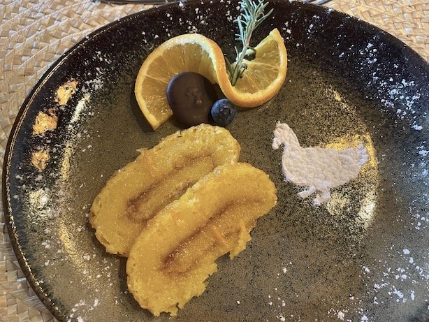 A sweet dessert with oranges and syrup