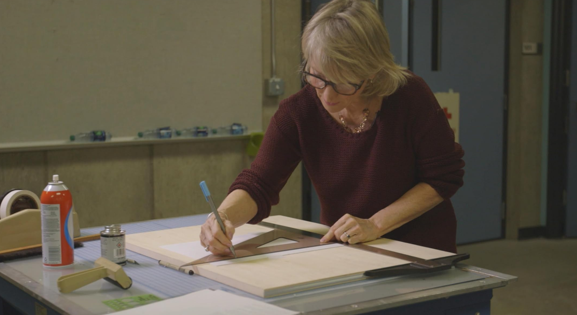 A graphic designer creating by hand and using tools