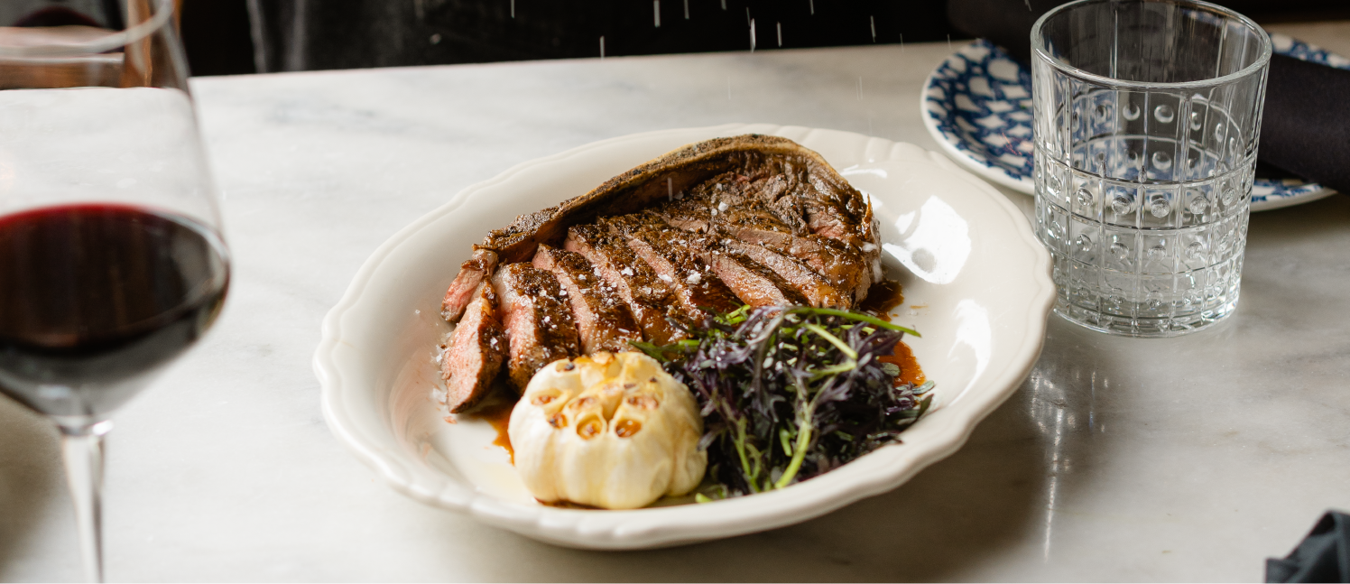 Black Swan Cut Steak being salted with glass of wine.png