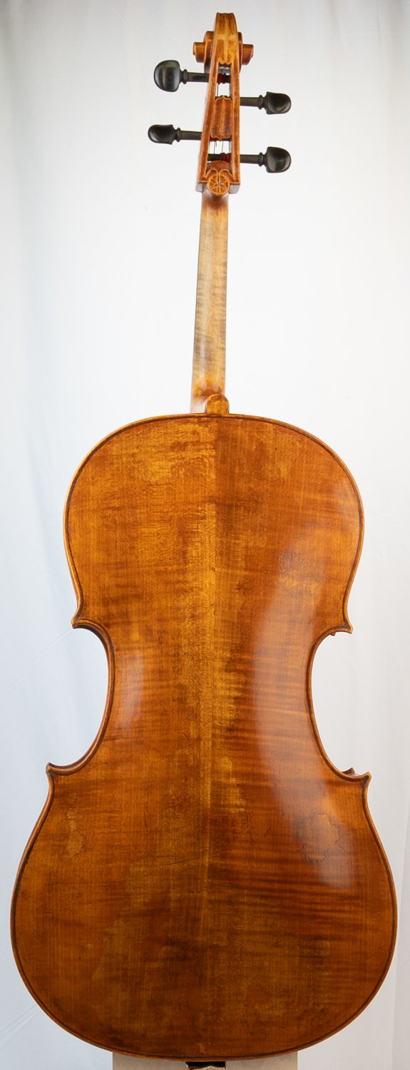 Back view of a wooden violin standing vertically against a plain background.