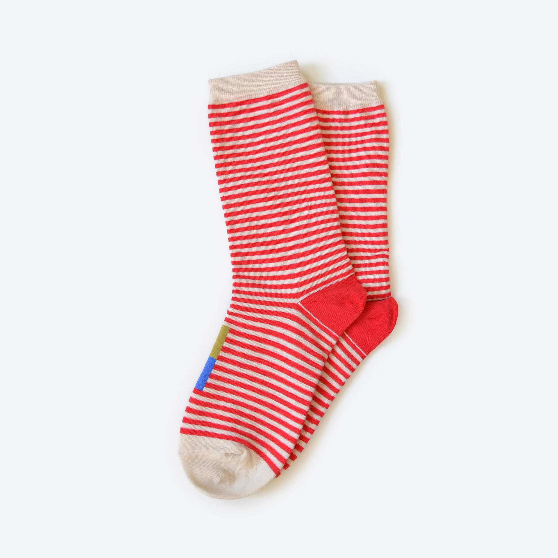 A pair of Hooray Crew Socks with red stripes and a blue and chartreuse color blocked bar on the front of the socks.
