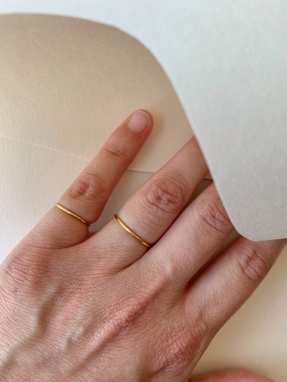 Hand wearing two Linea Rings