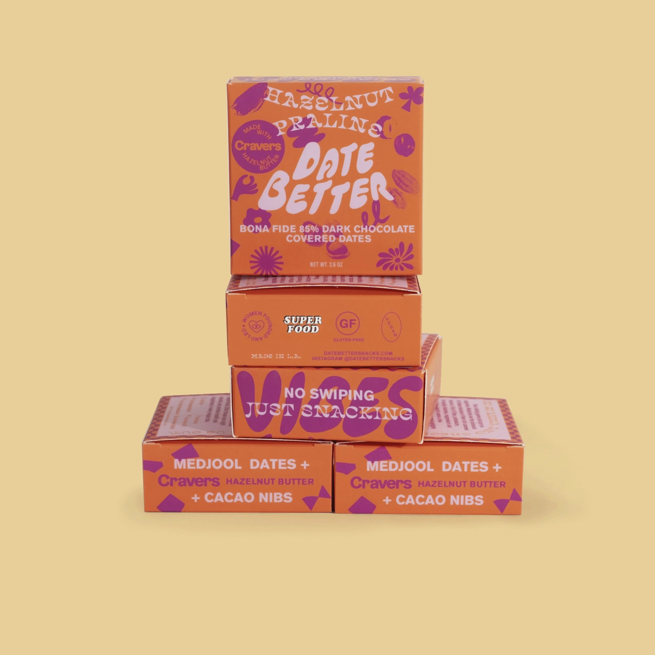 Stacked orange boxes of Date Better Snack in Hazelnut Praline.