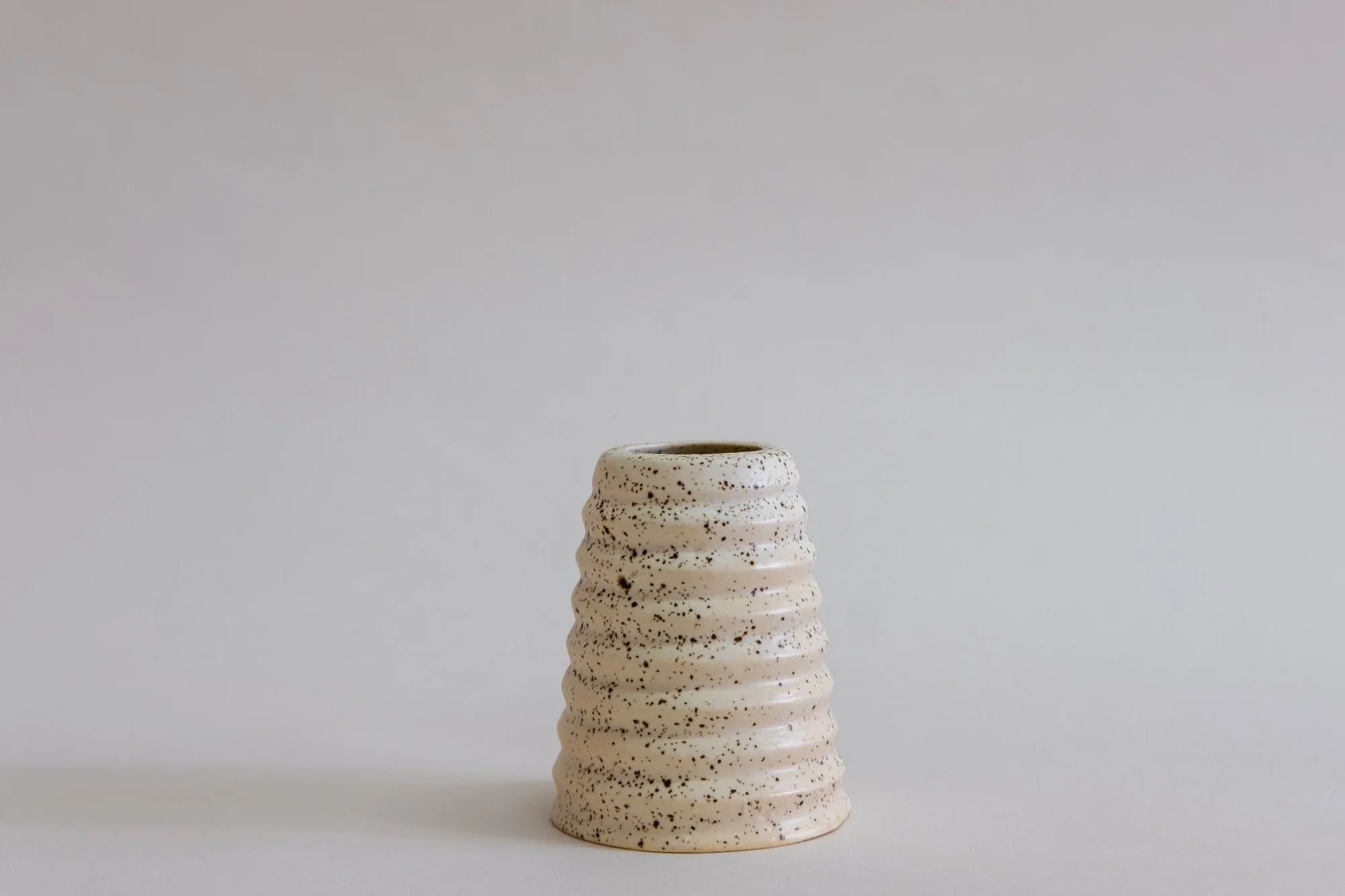 Utility Objects Eggshell Everything Vessel, a brown speckled vessel with horizontal ridges.