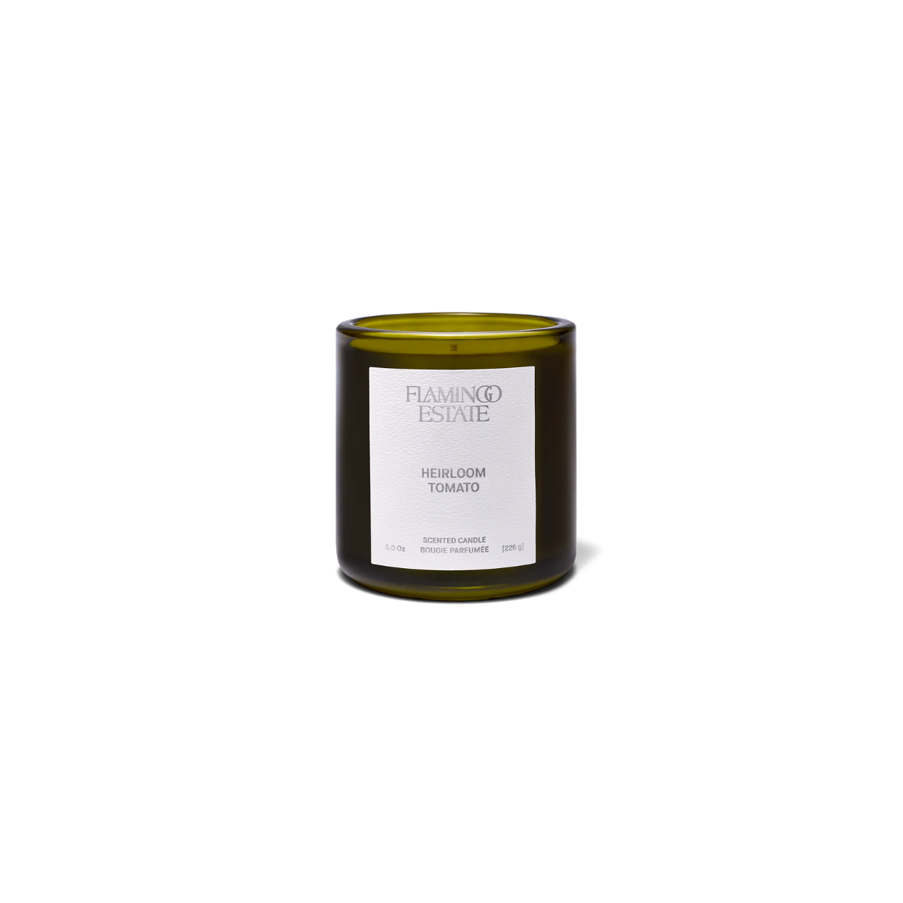 Flamingo Estate Heirloom Tomato Candle in a dark green glass jar with white label and silver print.