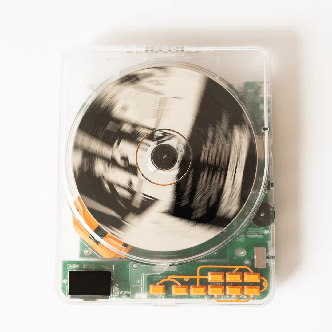 Retradisc CD Player, a clear CD player with green and orange accents.