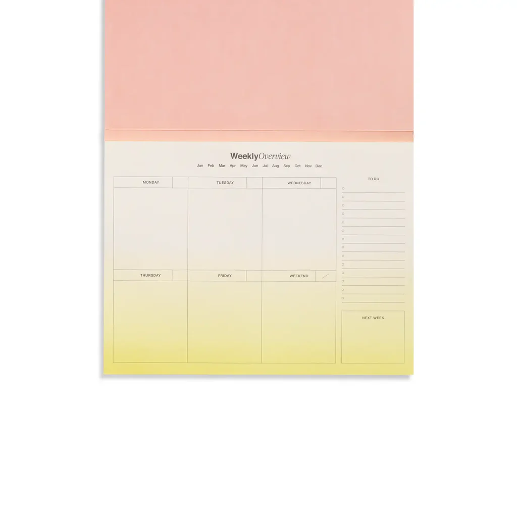 An open Bright Floral Weekly Desk Planner, revealing  lime ombre pages.