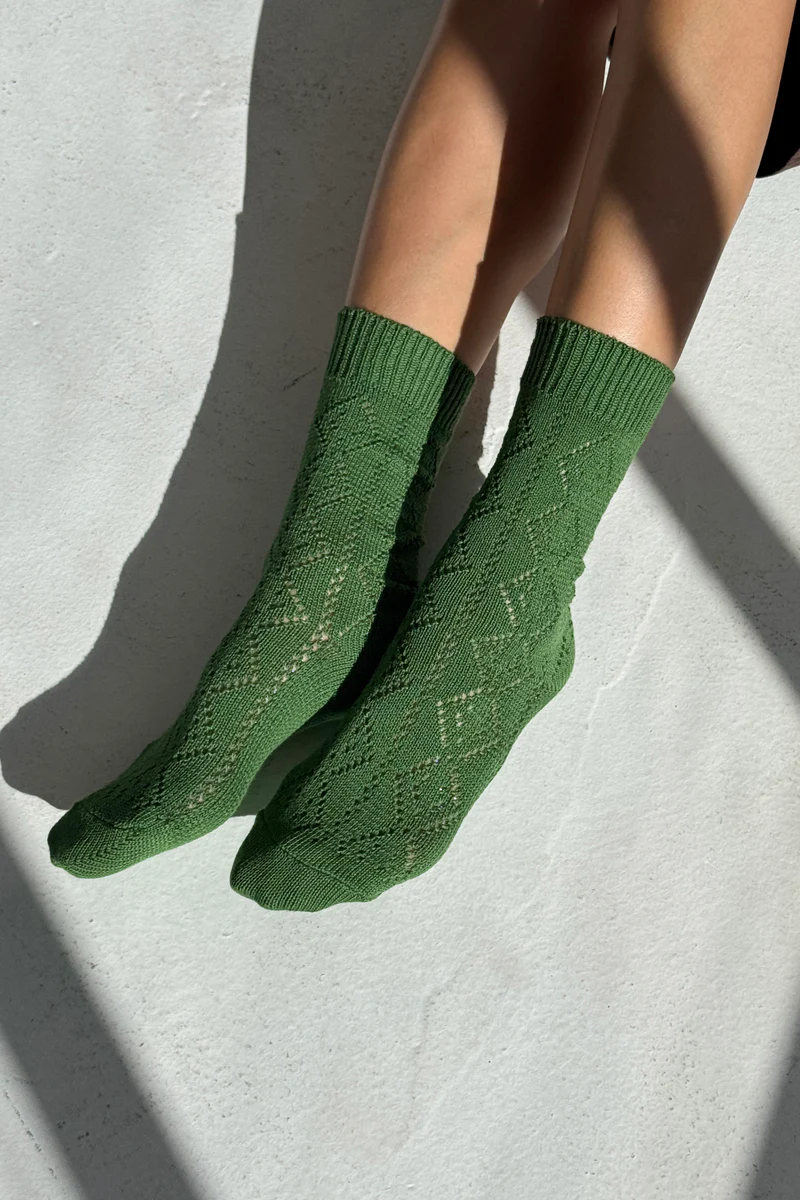 A model wearing Le Bon Shoppe Modal Eyelet Socks in Green.