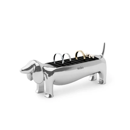 A chrome ring holder in the shape of a dachshund, with a velvet padded base for rings.