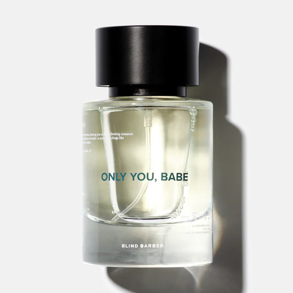 A clear glass bottle with a black top containing Blind Barber Only You, Babe Eau de Parfum.