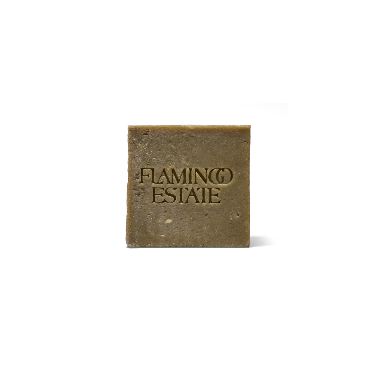 Flamingo Estate Rosemary Green Leaf Parsley Soap Brick, a square earthy colored soap with "FLAMINGO ESTATE" indented into it.