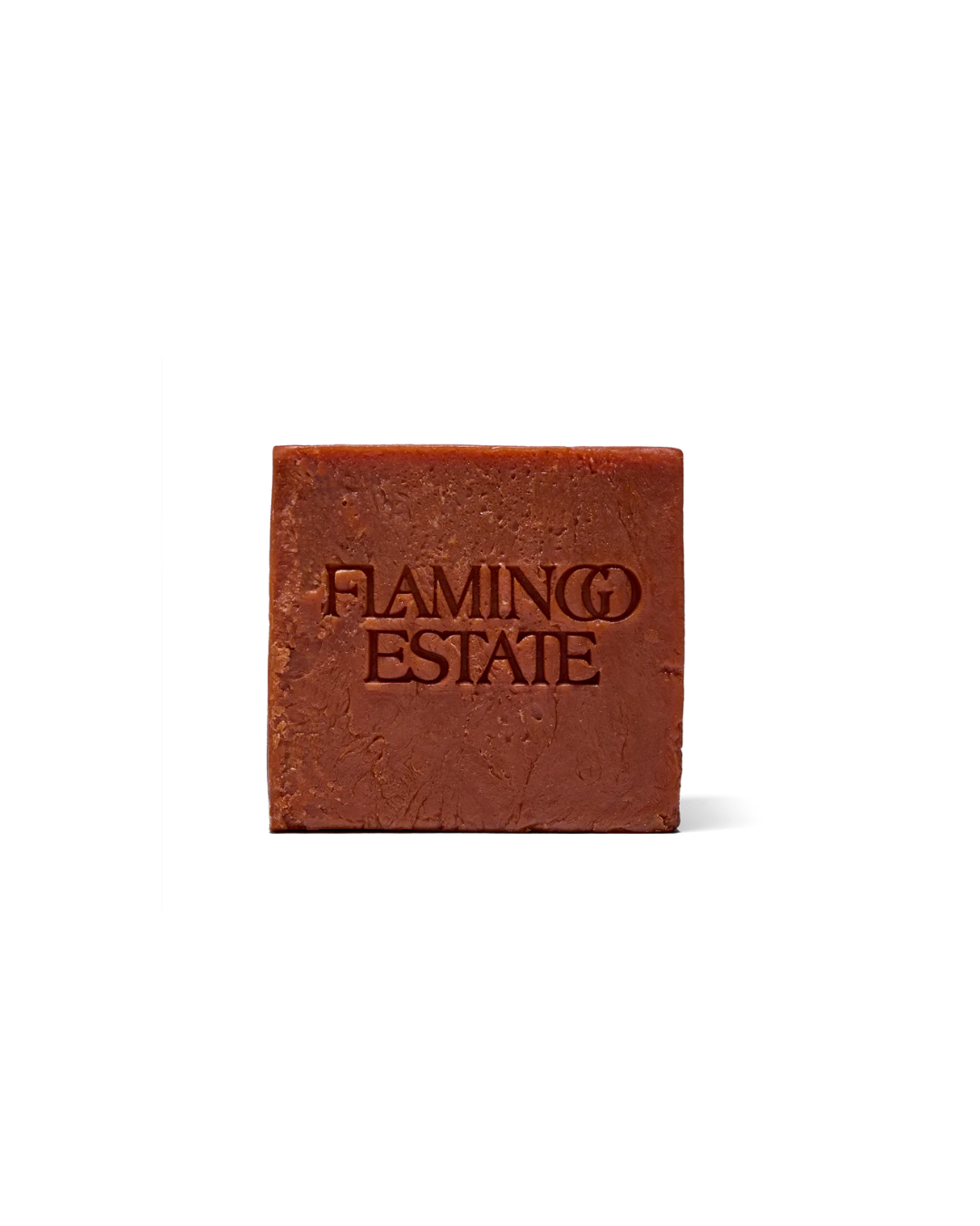 Flamingo Estate Heirloom Tomato Soap Brick, a dark, earthy orange square-shaped soap with "FLAMINGO ESTATE" carved into it.