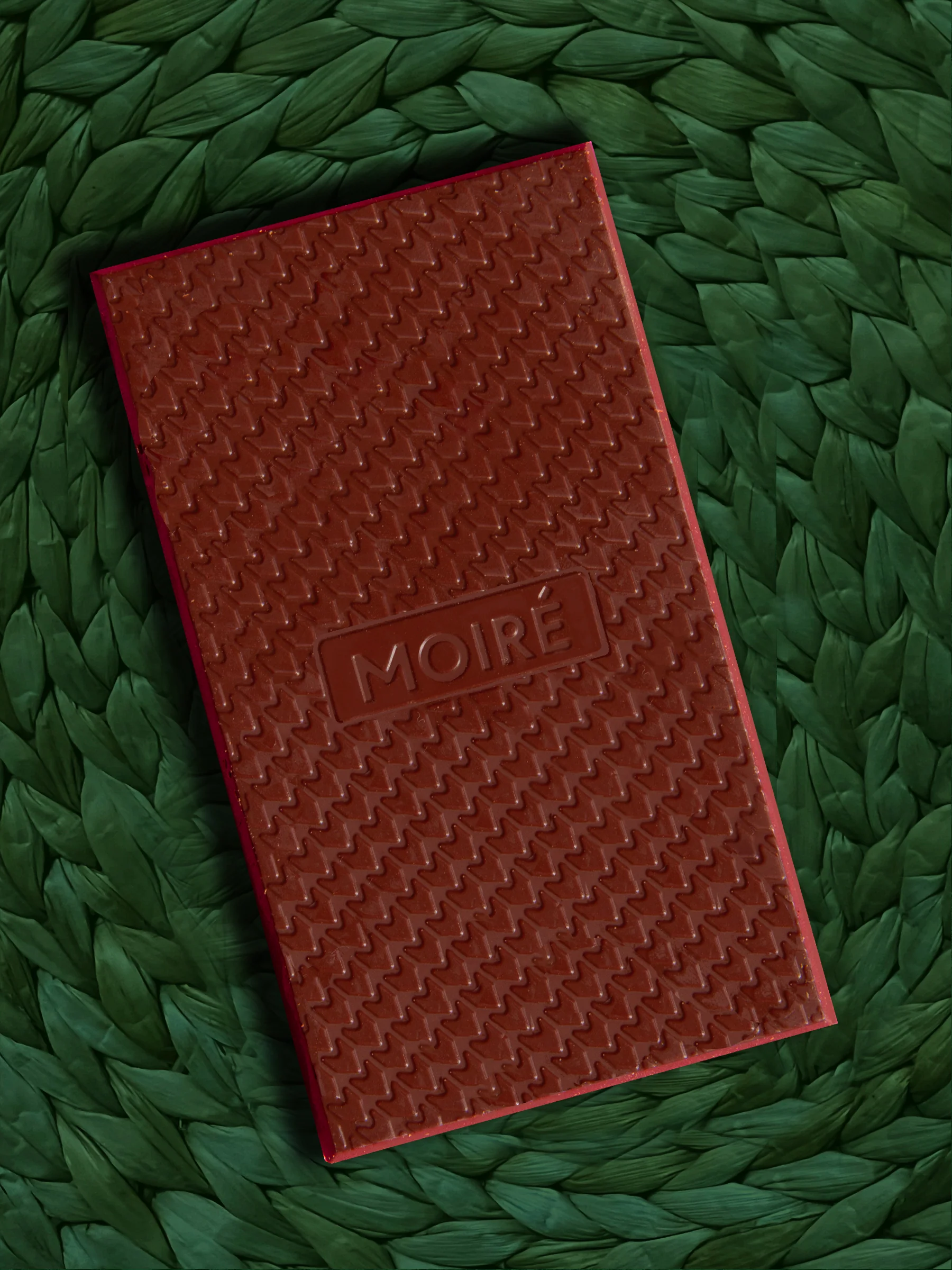 An unwrapped bar of Moire Andean Lucuma M!lk Chocolate on a shag background.